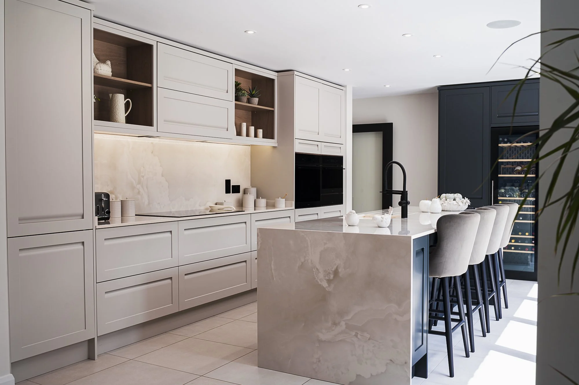 a modern kitchen with marble surfaces