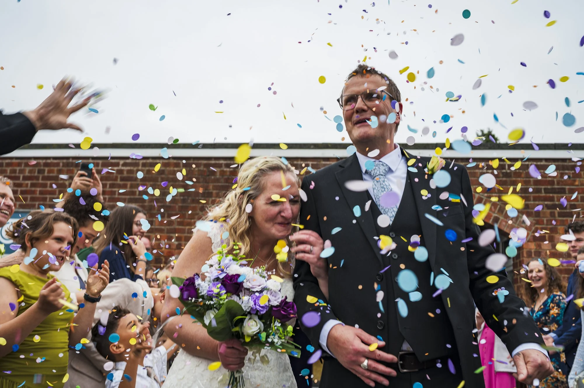 bride and groom in confetti