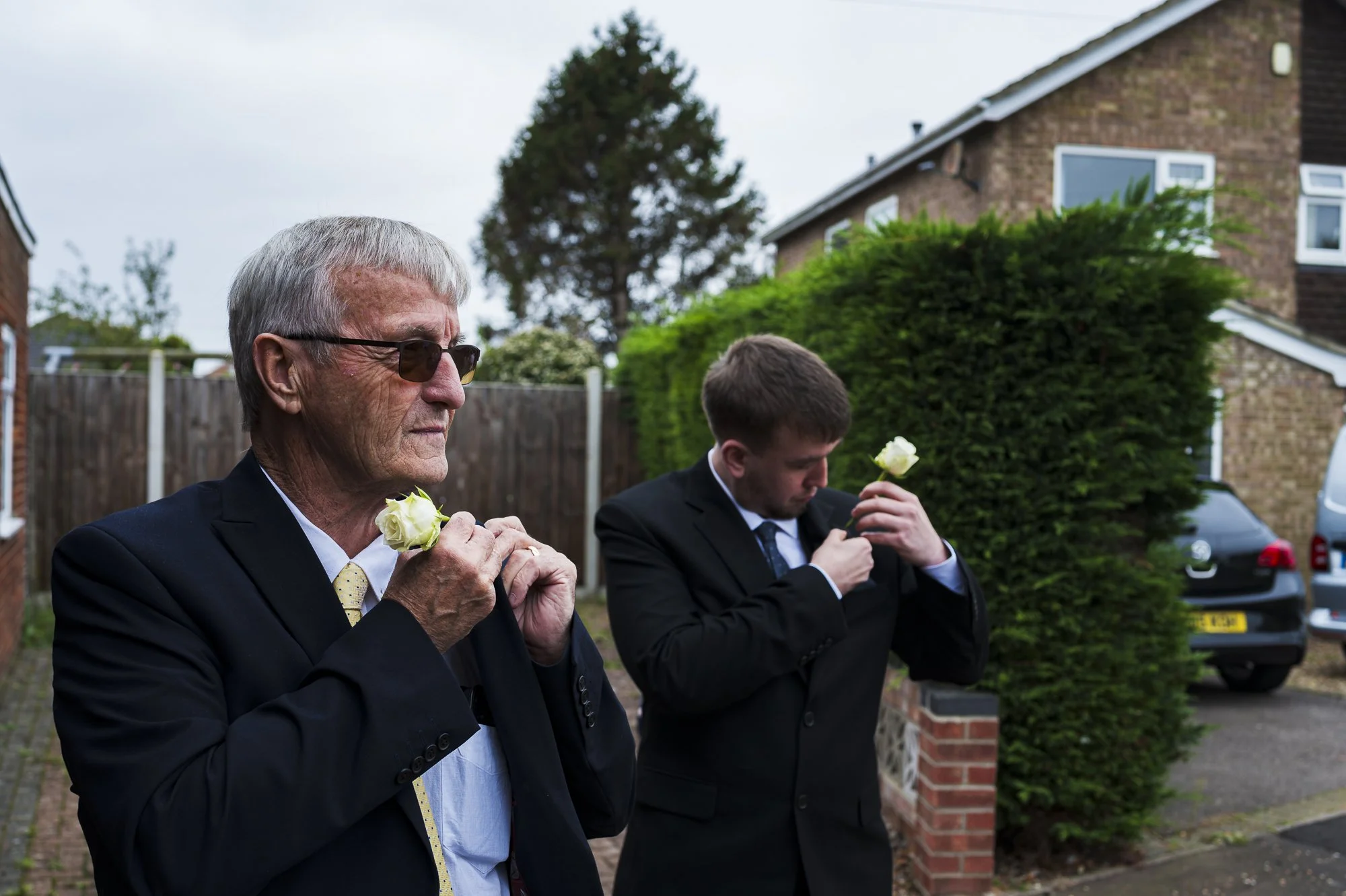 ushers place button holes