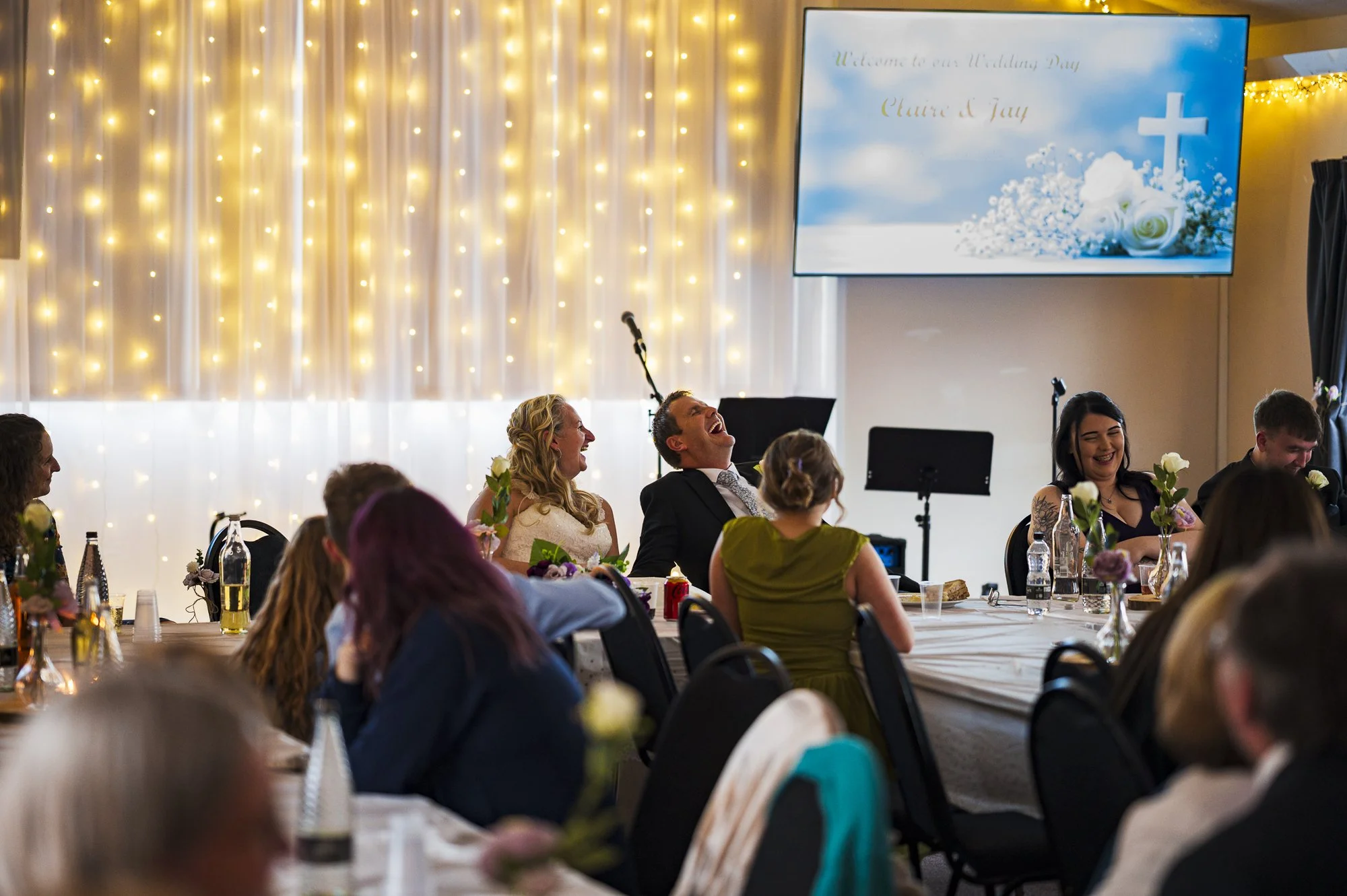 groom laughing during speeches