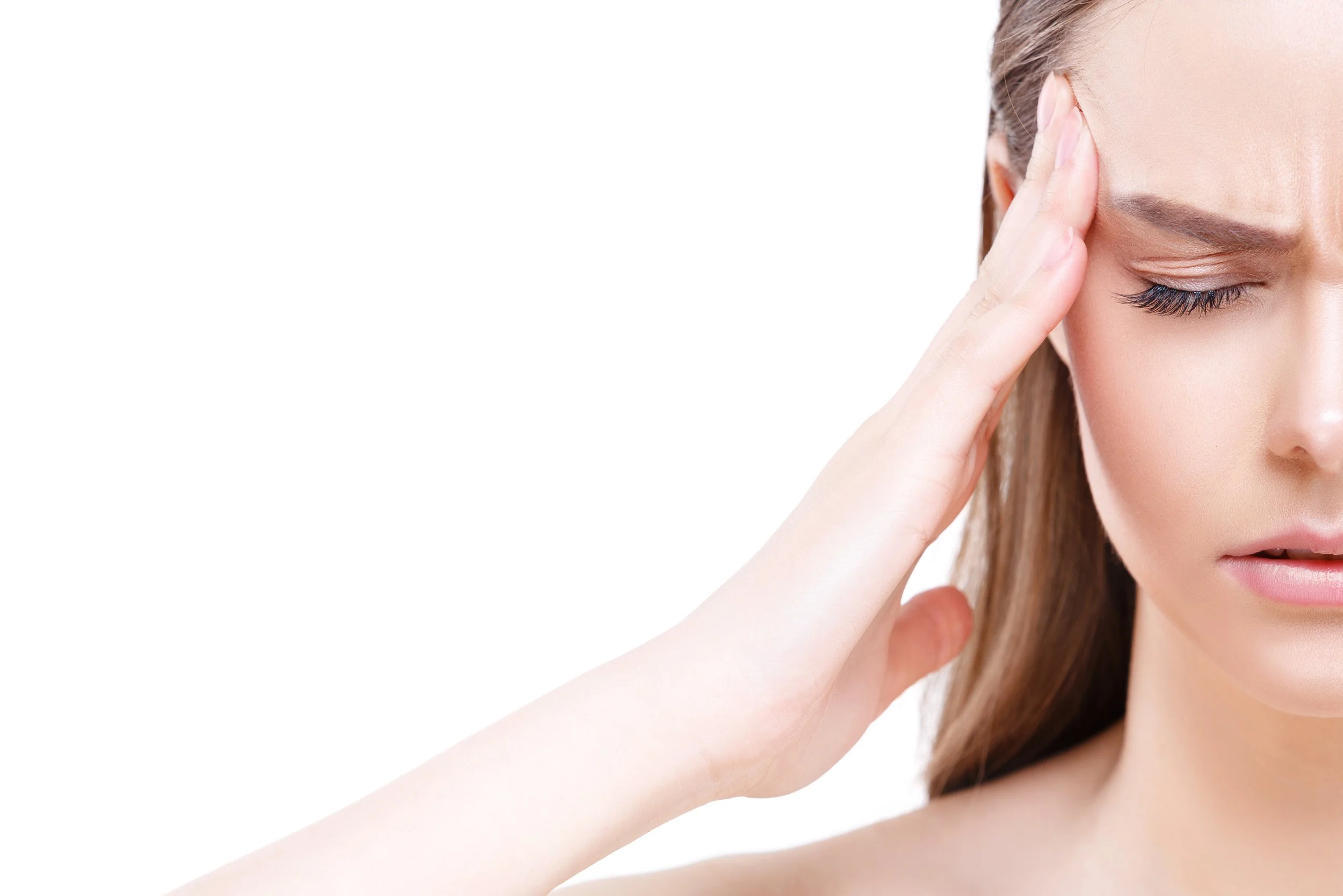 A woman with closed eyes, touching her forehead with her fingers, appearing to experience a headache or stress.