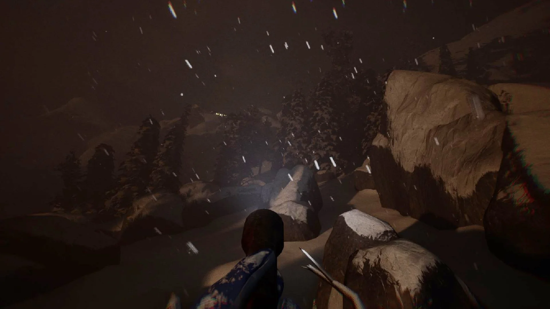 First-person perspective of a person walking between large rocks and boulders in a dark, snowing outdoor environment.