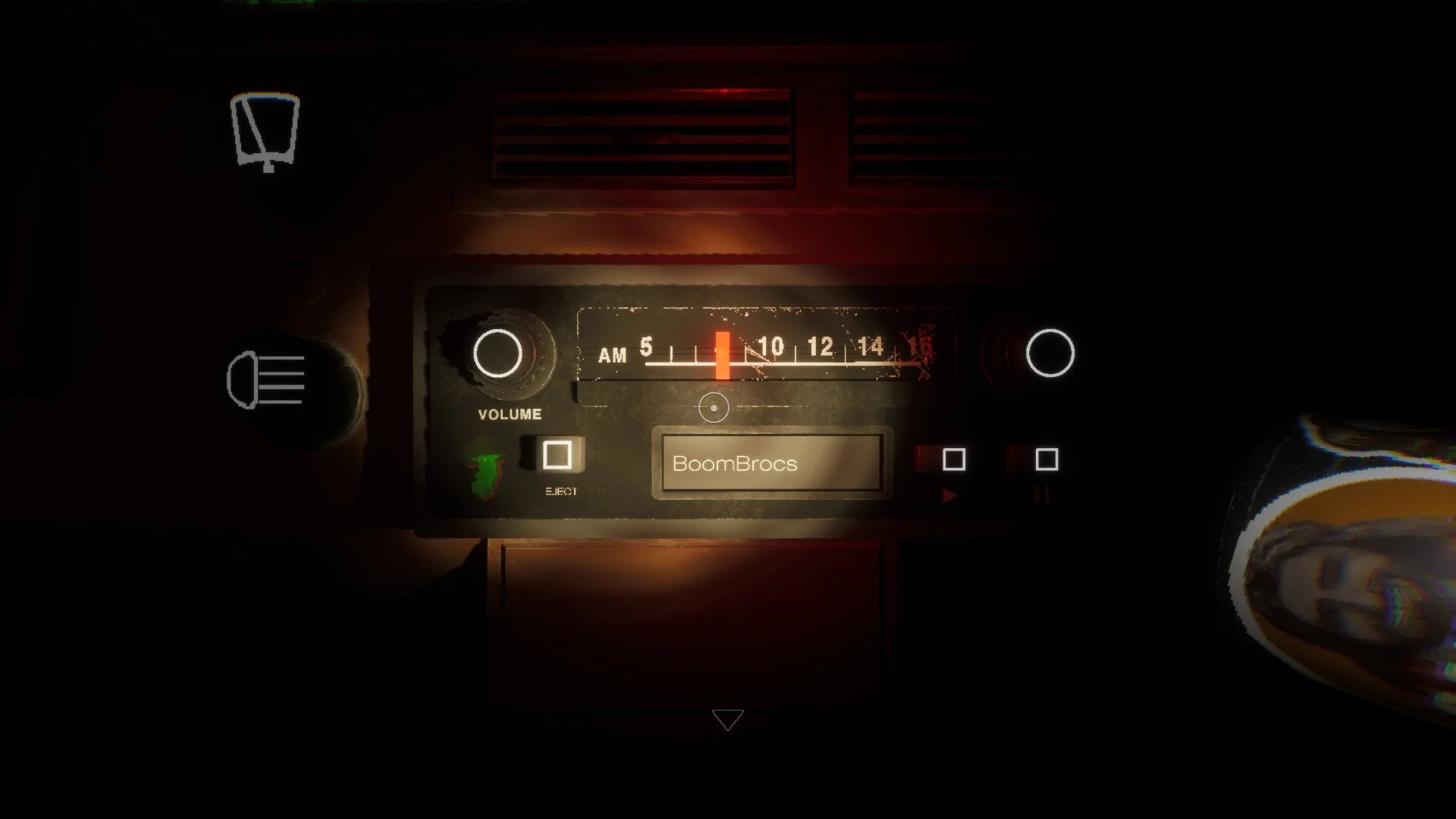 A vintage car radio with a digital display tuning to 10 AM, labeled 'BoomBrocs'. Surrounding controls include volume knob, eject button, and tuning dial. The dashboard is partly visible with light reflections.
