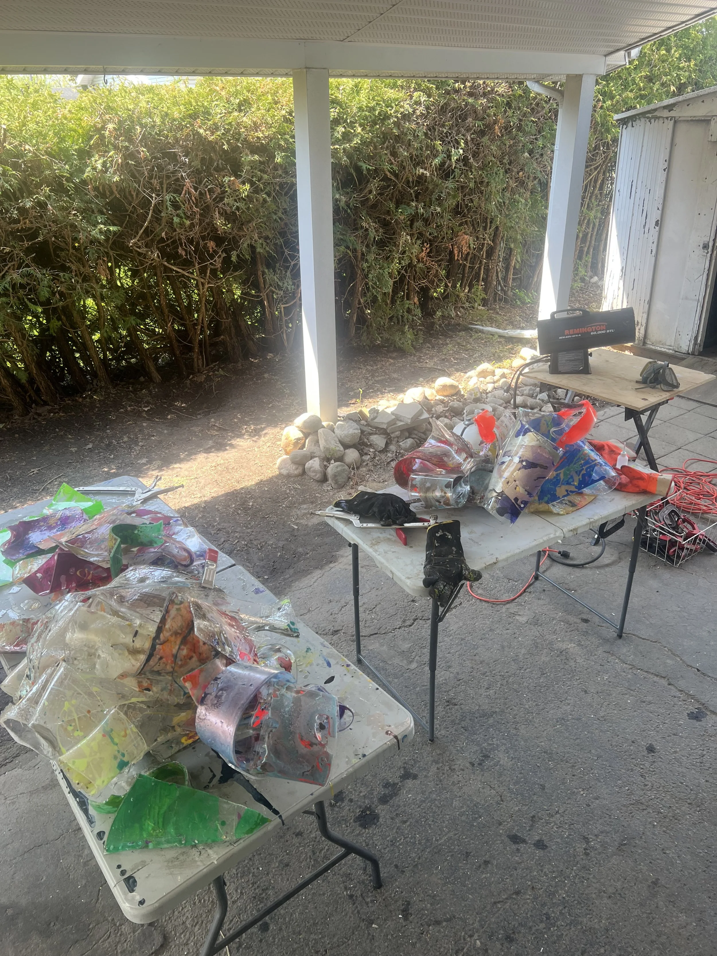 Mike Vandenberg, a Canadian contemporary artist, is working on a colorful, abstract sculpture in his outdoor studio.