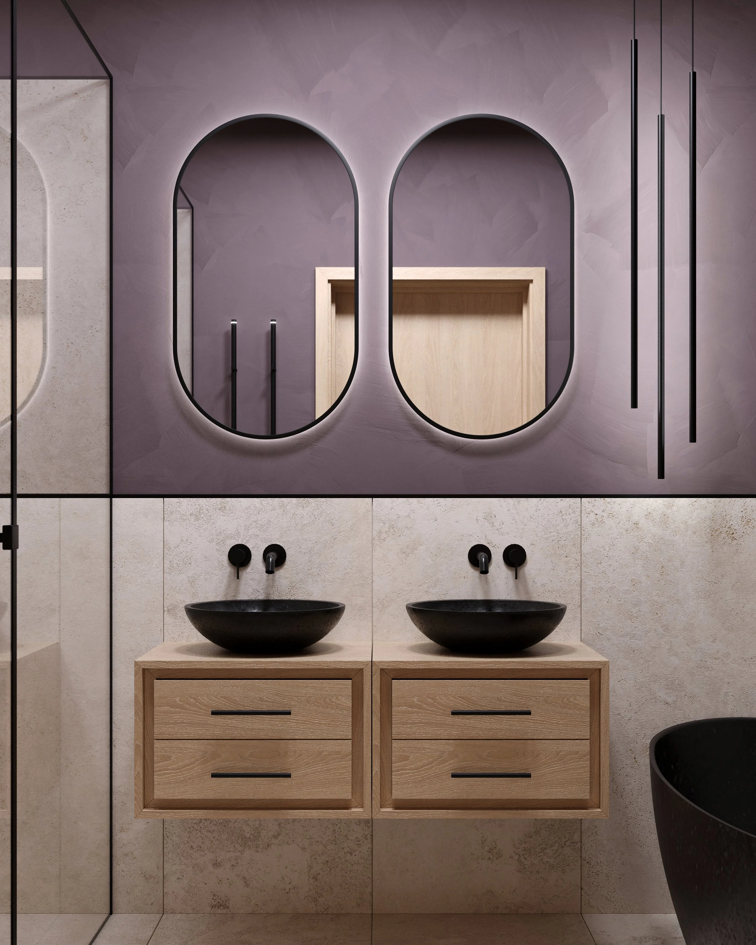 Modern bathroom with two black vessel sinks on wooden vanities, large oval mirrors, purple wall, beige tiled wall, and black fixtures.