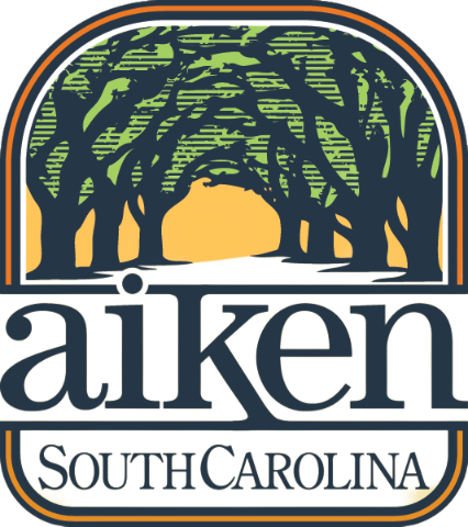 Logo of Aiken, South Carolina with silhouette of tree-lined road and text "aiken South Carolina."