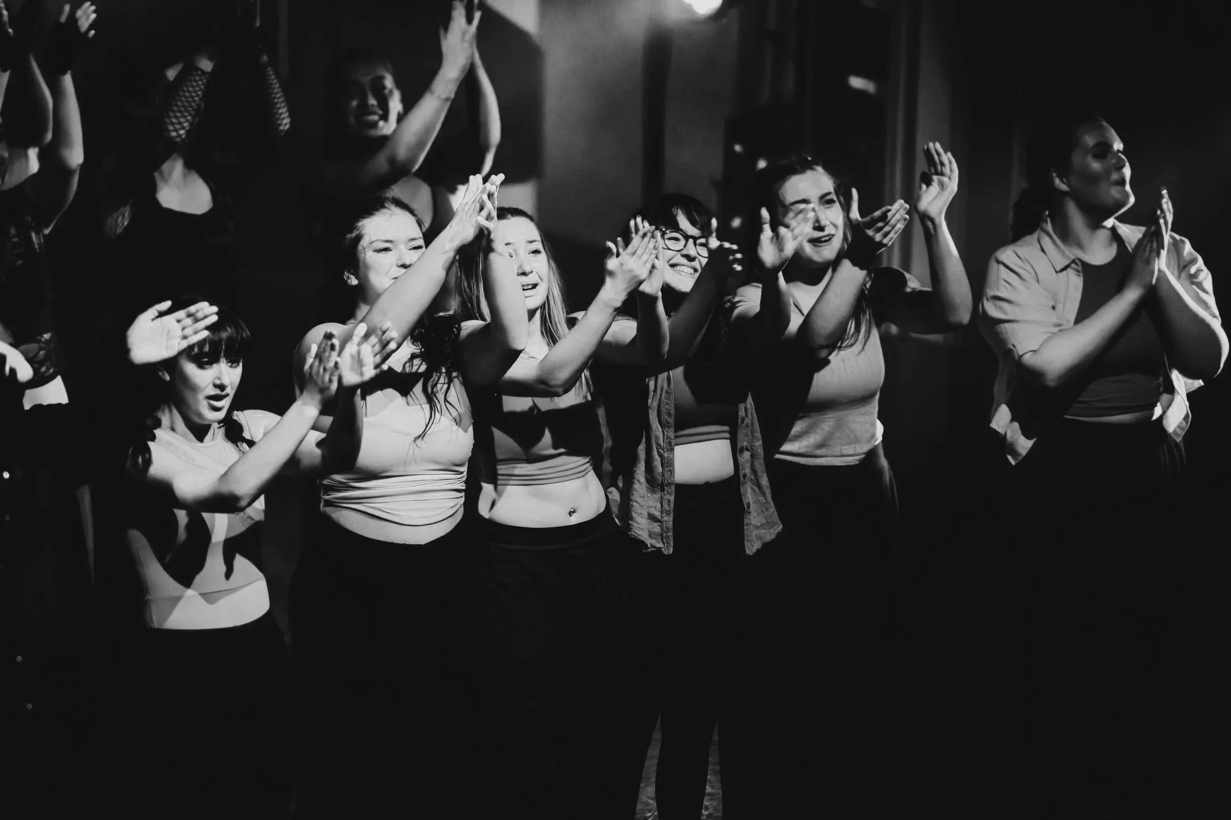 Filled with emotion, five dancers in a line for 'bows' applaud upwards to the tech box. All of them are crying but their faces still convey such joy and pride.