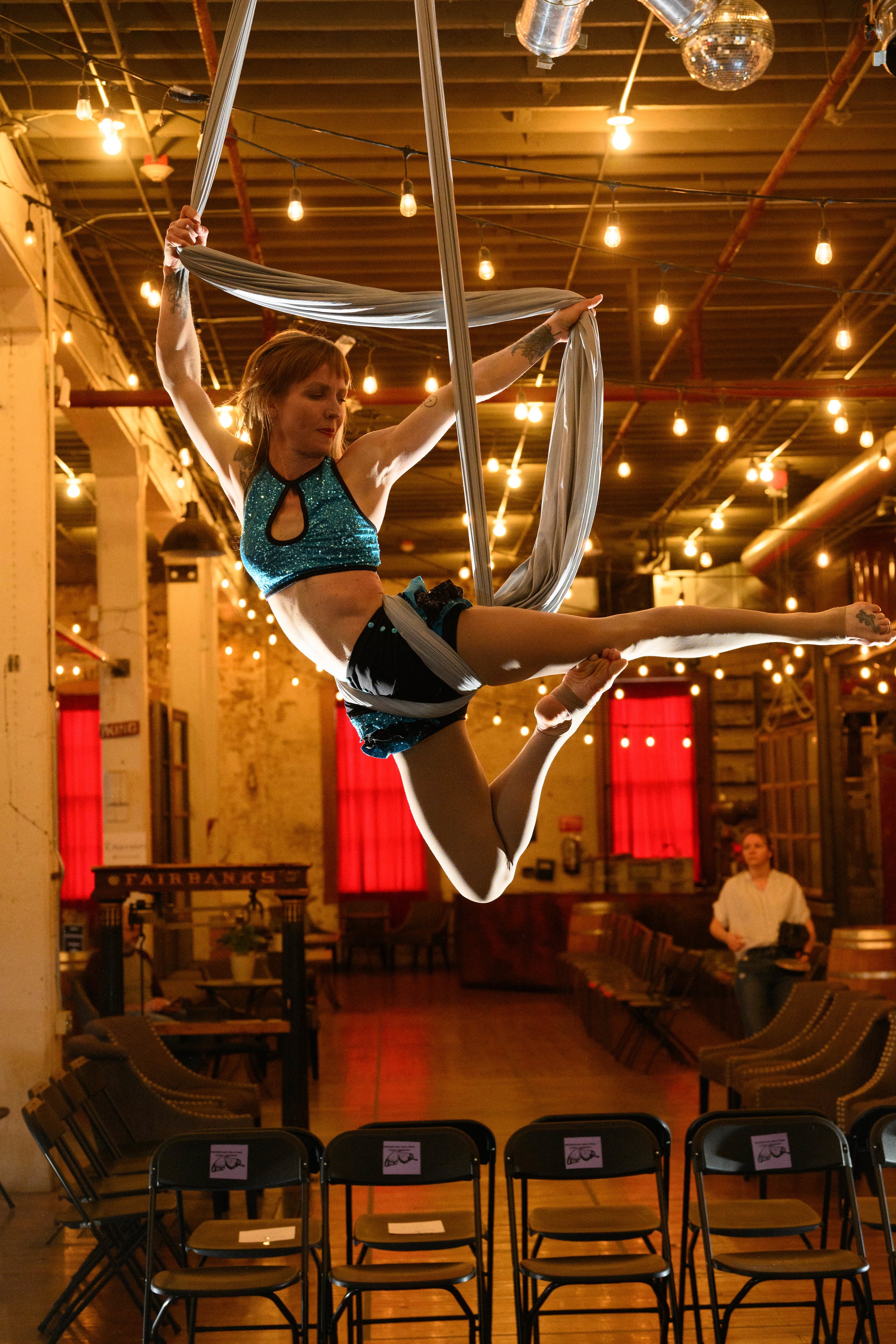 Aerialist Shelly from Coil Studios performing on aerial silks.