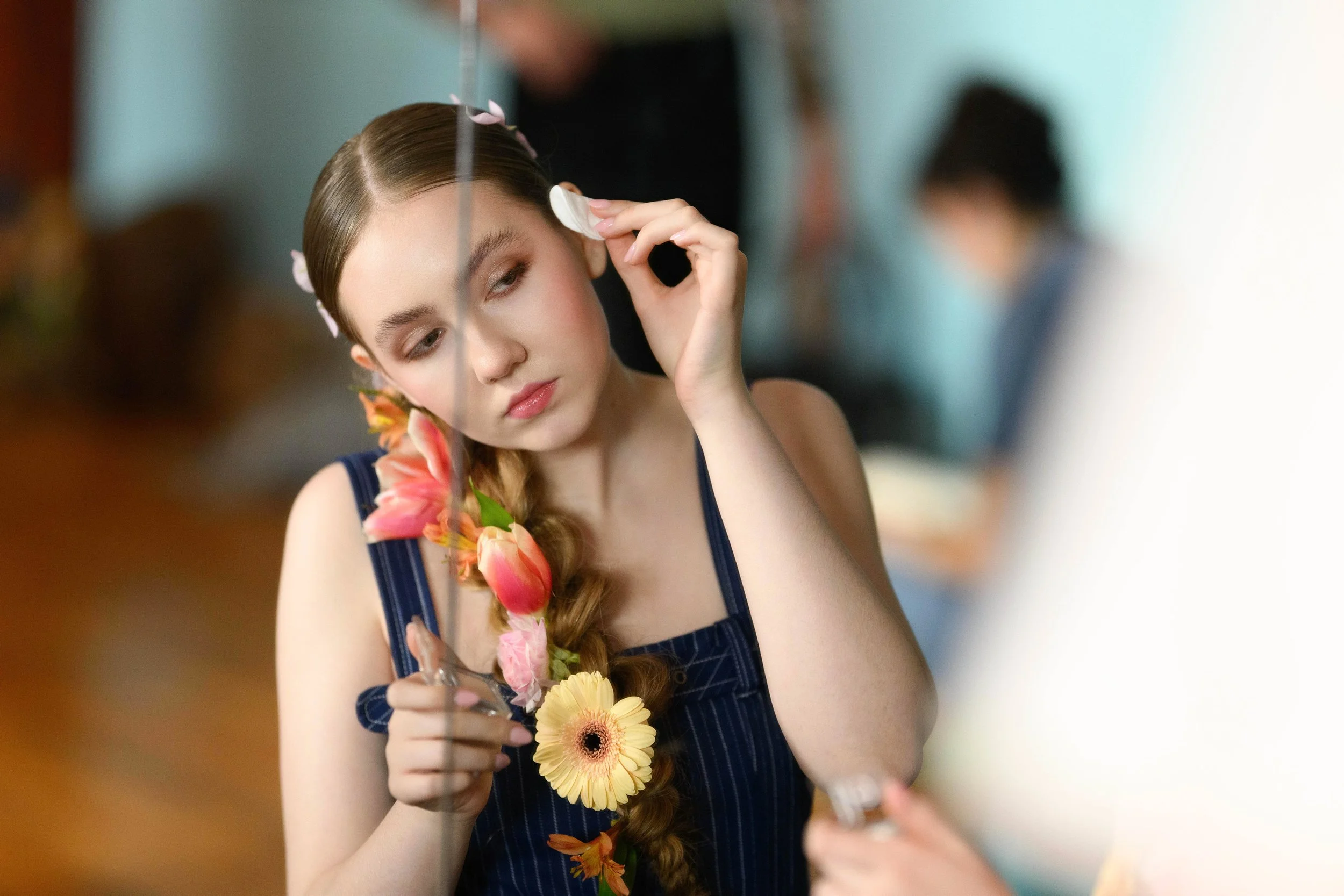 Model and artist Audrey Lisette getting ready for the runway. Hair flowers from Sprig and Thorn. PC: Scott Martinez