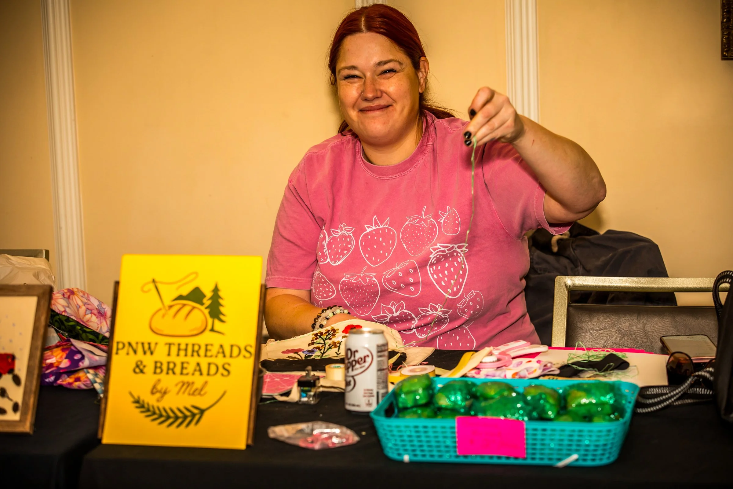 Mel, owner of PNW Threads and Breads creating art at her vendor table after the runway show PC Gabriel (Picture Perfect Visions)
