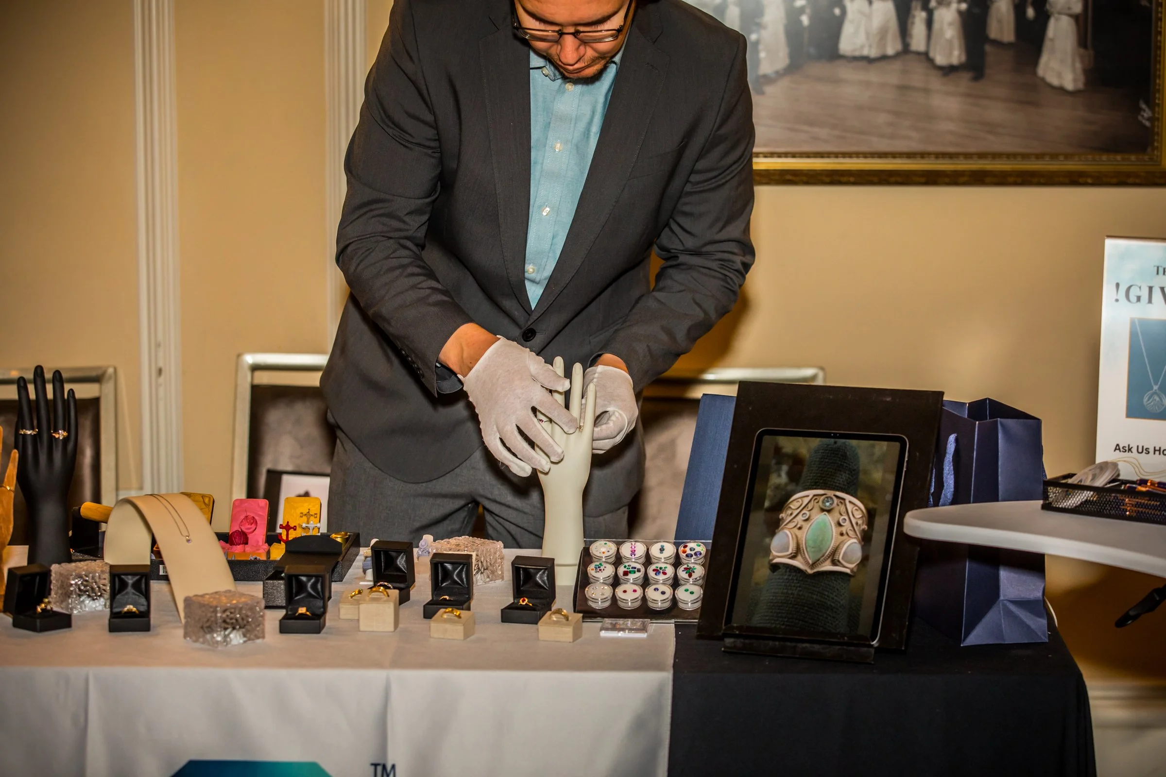 Teneff Jewelry's team carefully setting up their display for their vendor table PC Gabriel (Picture Perfect Visions)