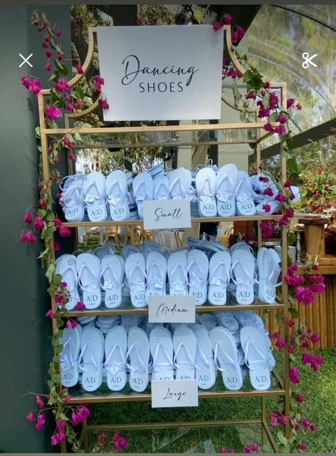 Display of various sizes of white dancing shoes with