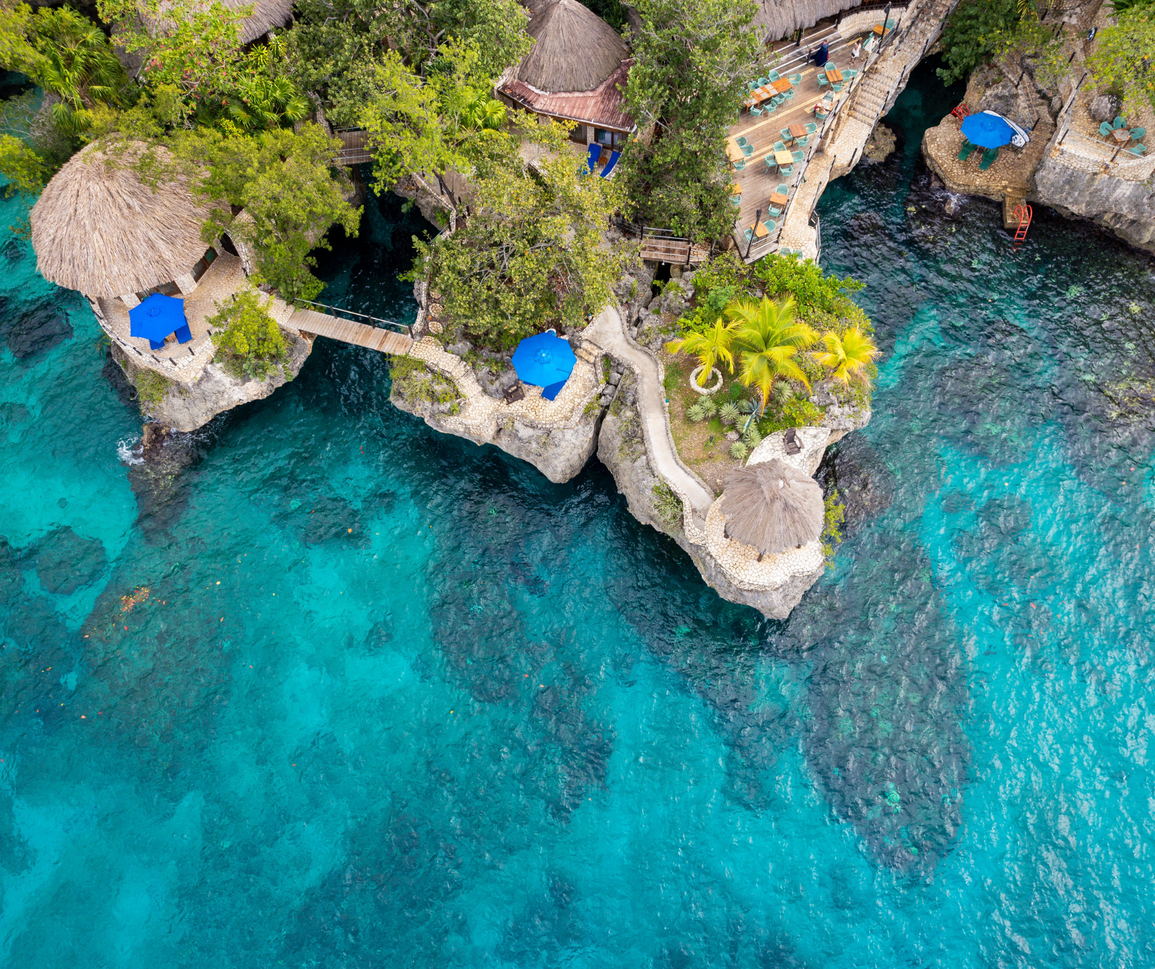 Sunset view of Negril, Jamaica, featuring Seven Mile Beach, dramatic cliffs, and the Caribbean coastline.