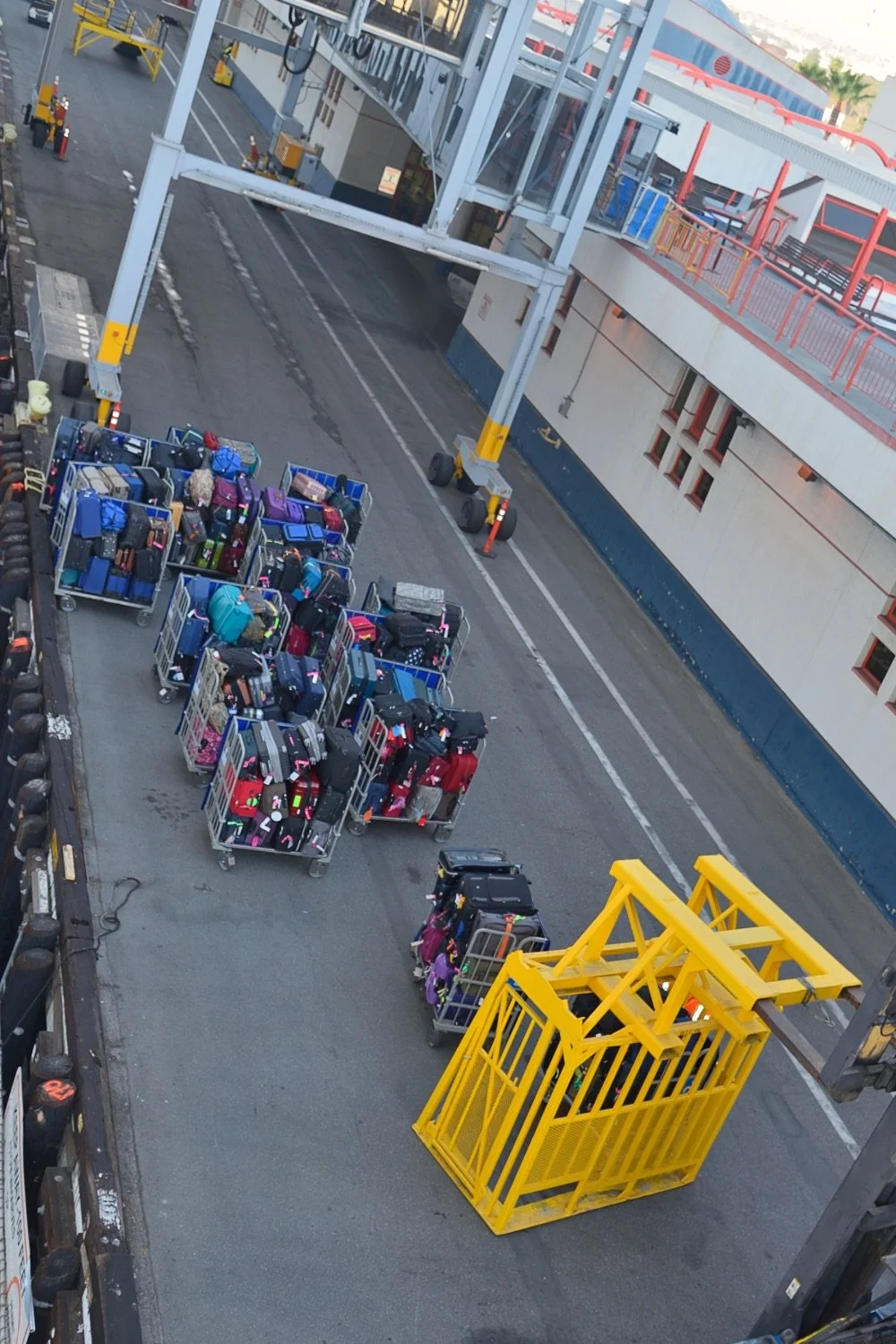 Cruise terminal luggage being transported in rolling carts before debarkation