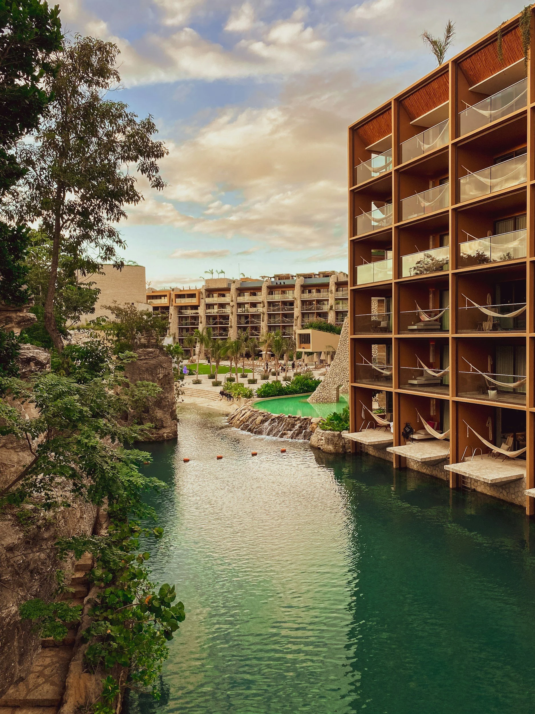 River-facing suites and jungle-integrated architecture at Hotel Xcaret Mexico in Riviera Maya with natural waterways and balconies