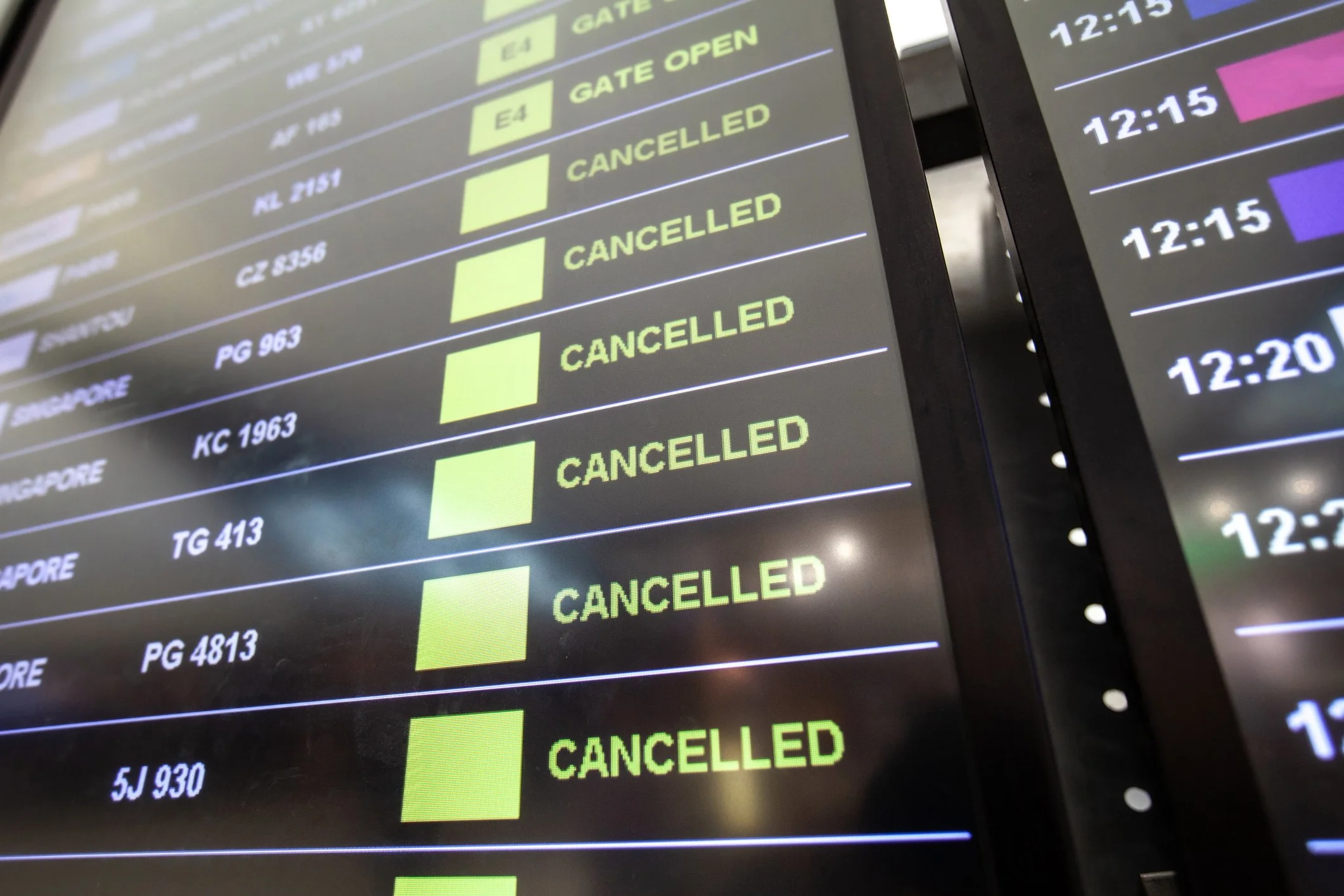 Airport departure board displaying multiple canceled flights during widespread airline operational disruption and bankruptcy-related travel uncertainty.