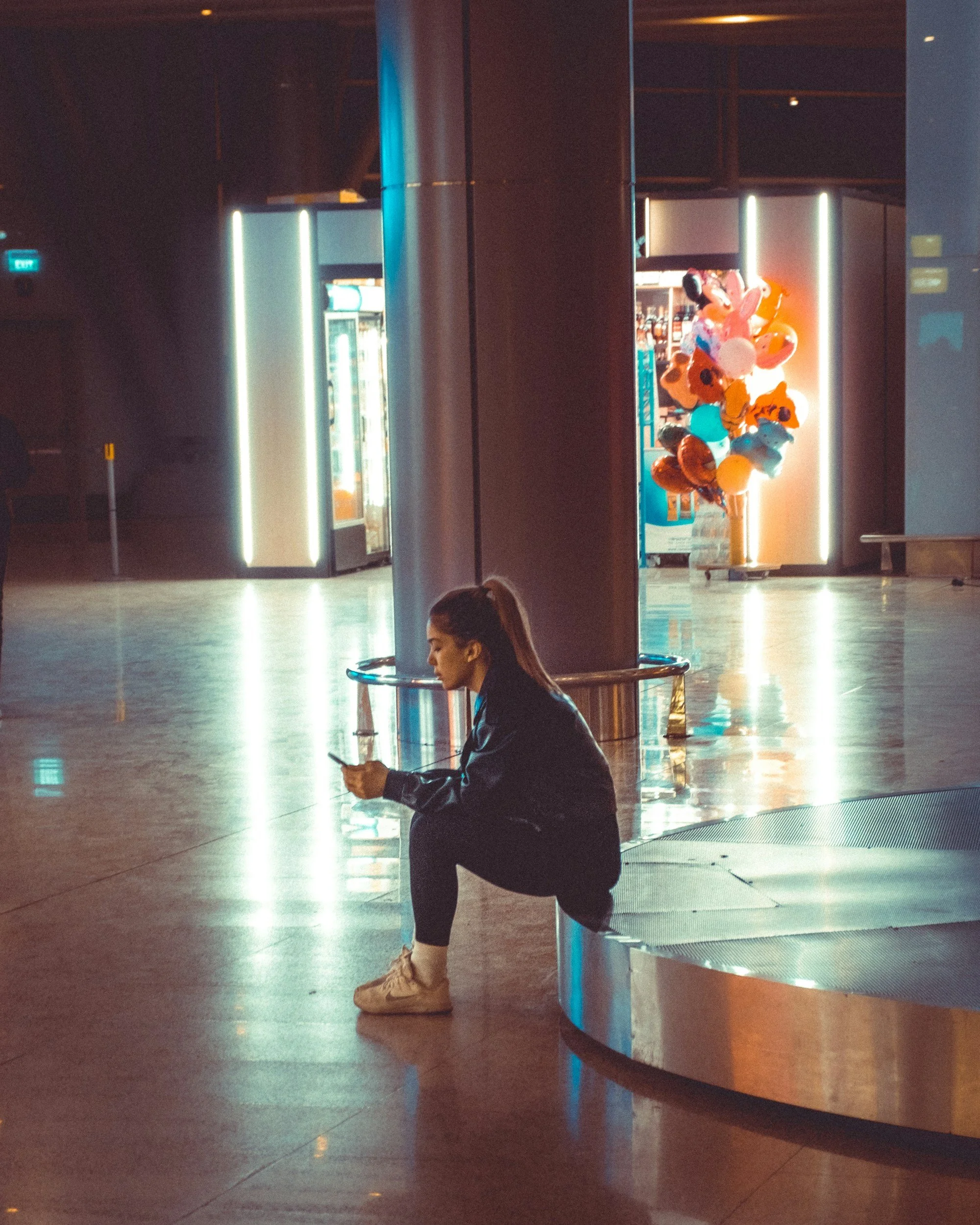 Traveler sitting alone inside an airport terminal during travel disruption caused by airline cancellations, refund uncertainty, and bankruptcy complications.
