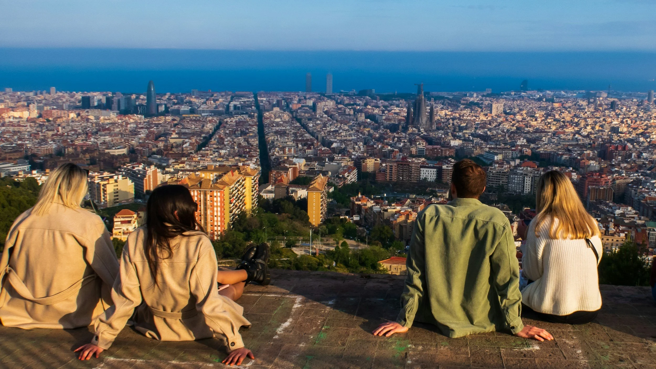 Travelers overlooking the city of Barcelona while reflecting on modern tourism and intentional travel