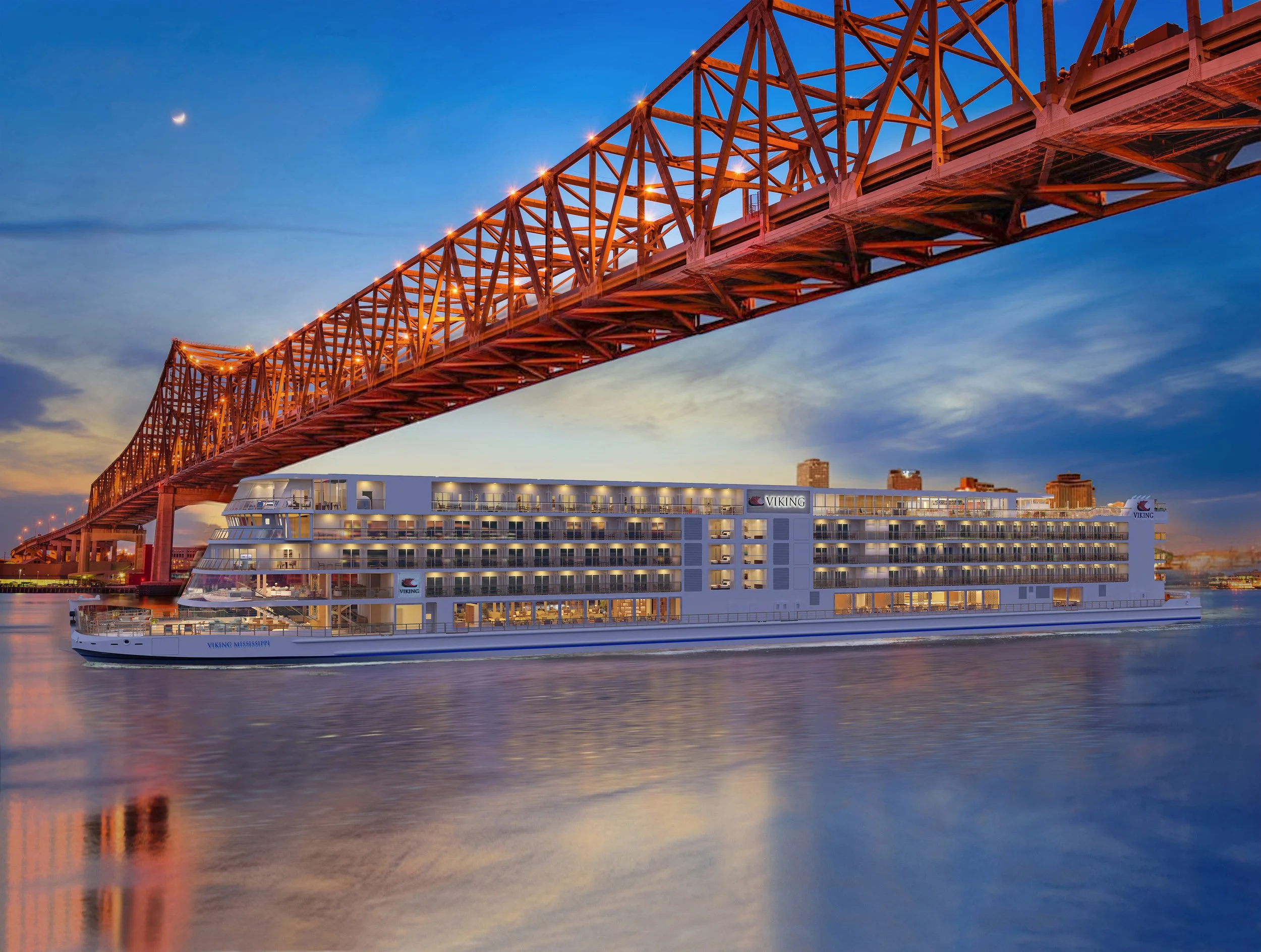 Viking Mississippi river ship sailing beneath bridge in New Orleans at dusk