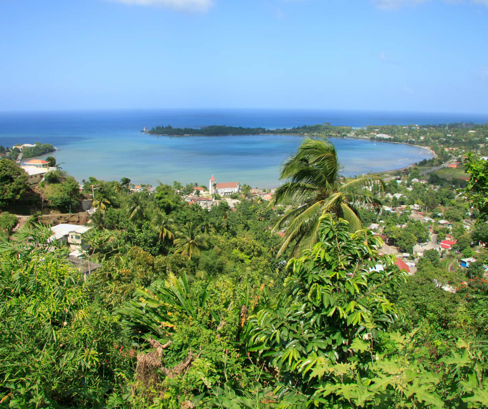 Lush tropical coastline overlooking Port Antonio, Jamaica, surrounded by rainforest and secluded beaches.