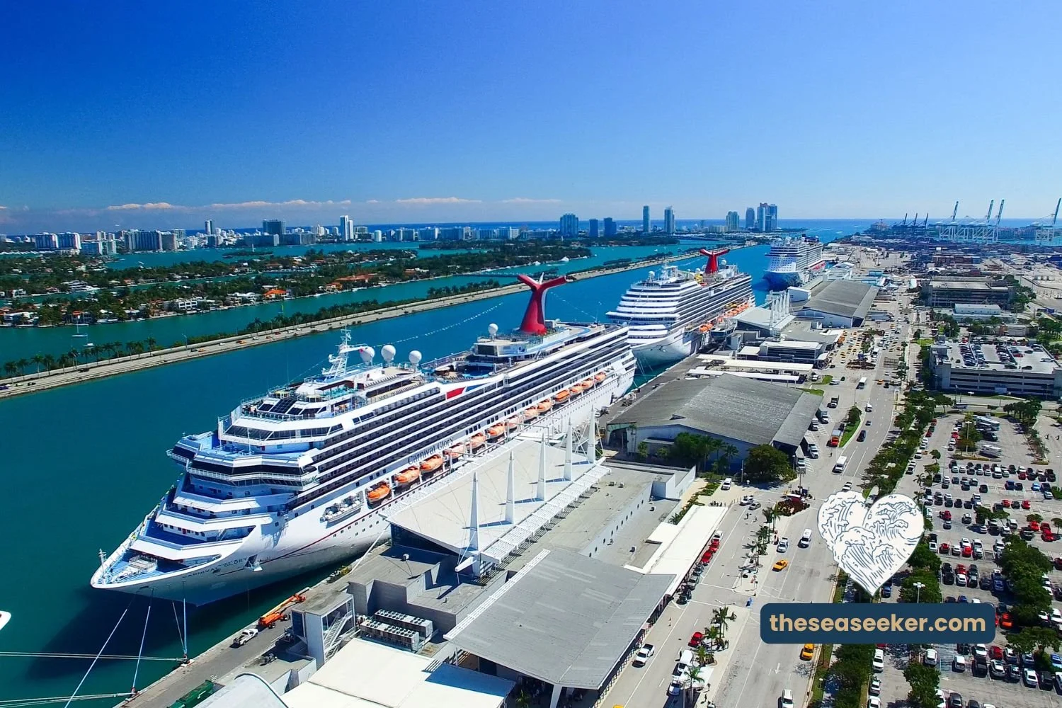 Aerial view of Carnival cruise ships docked at PortMiami with city skyline and terminals in the background