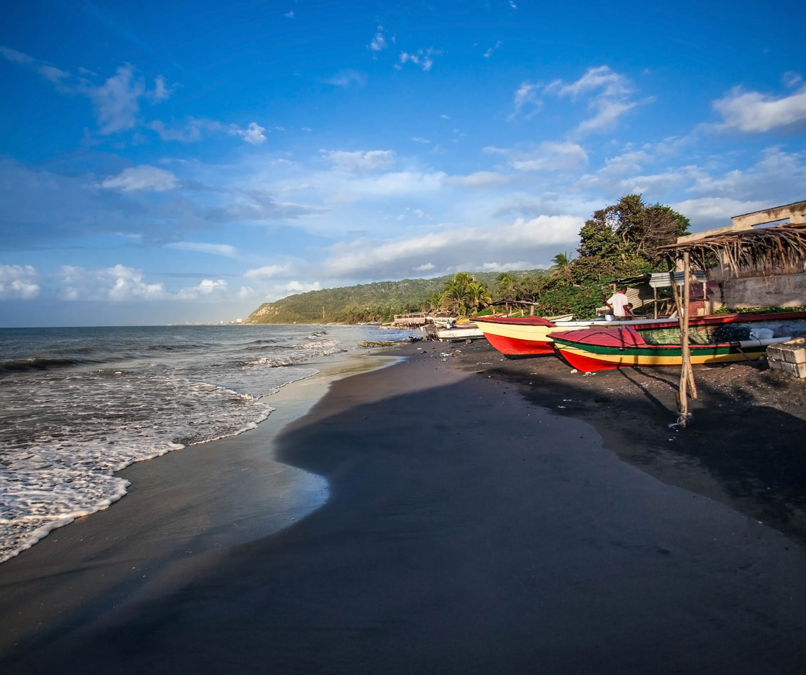 Peaceful shoreline at Treasure Beach, Jamaica, known for fishing villages, black-sand coves, and relaxed coastal scenery.