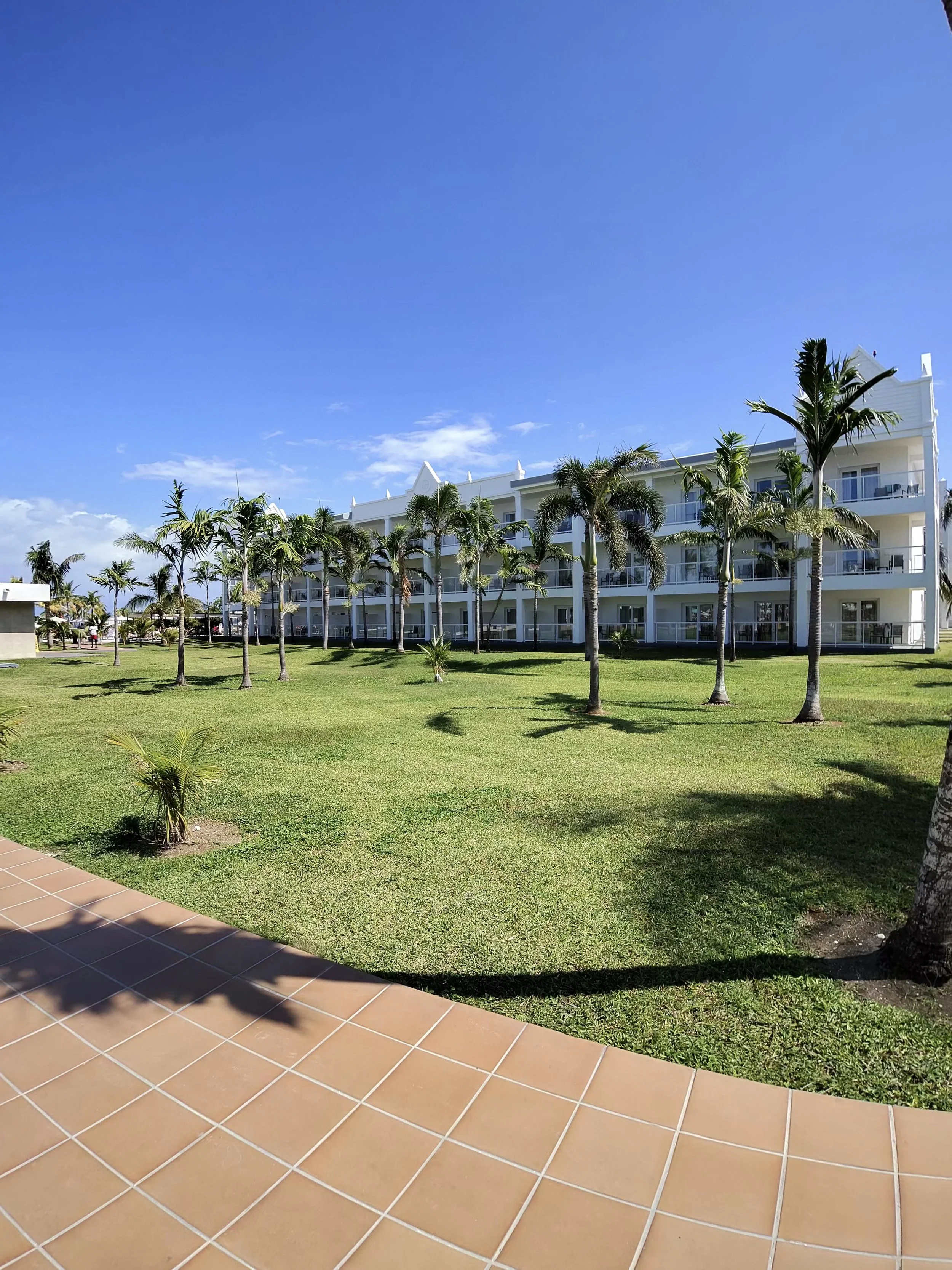 Resort buildings and palm-lined grounds at Riu Montego Bay in Montego Bay, Jamaica.