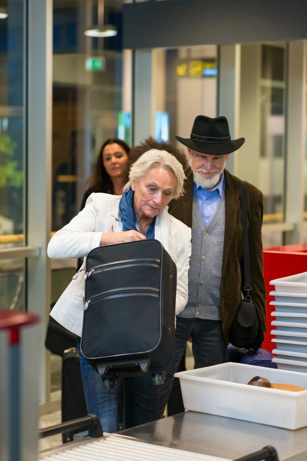 Cruise travelers going through TSA security with carry-on luggage