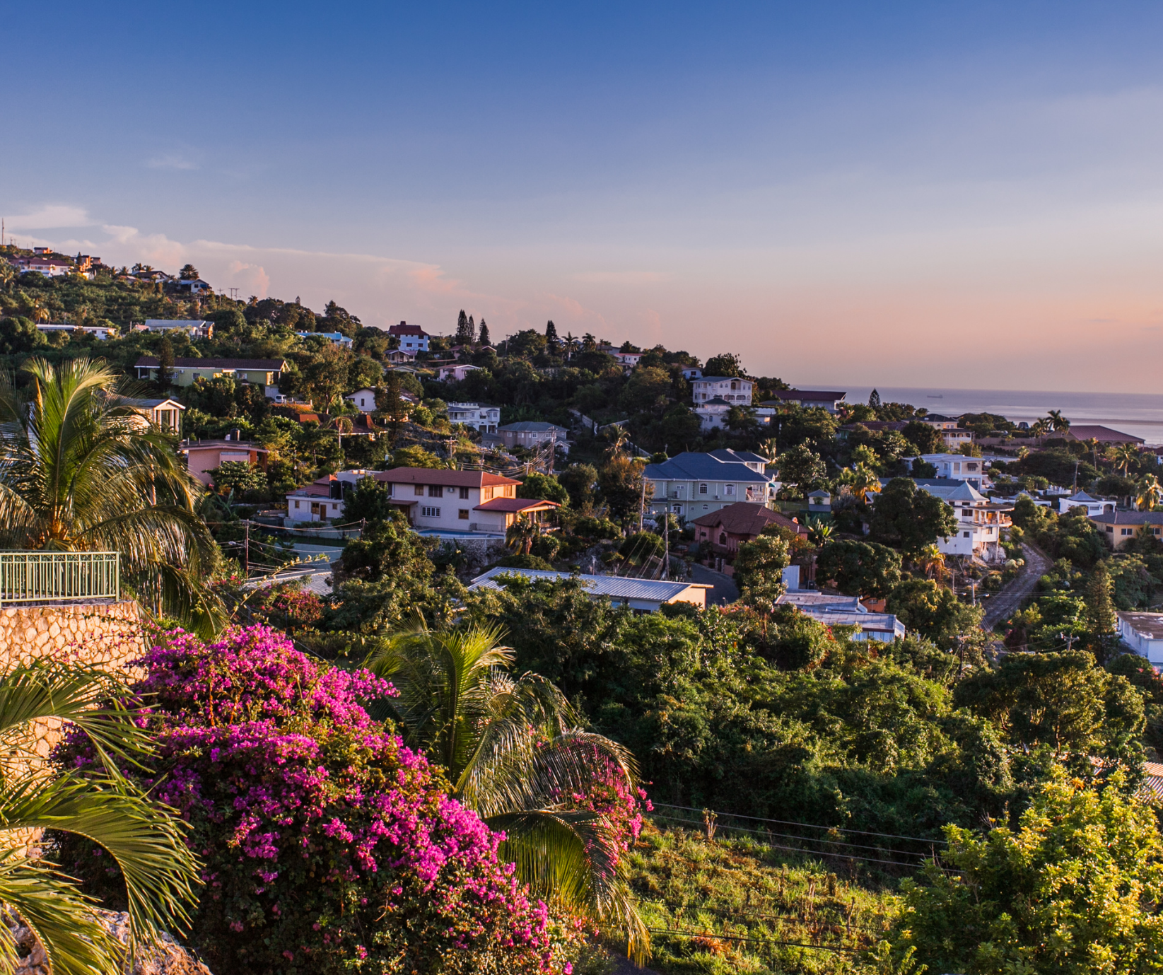 Scenic view of Kingston, Jamaica, with colorful neighborhoods set against the Blue Mountains.