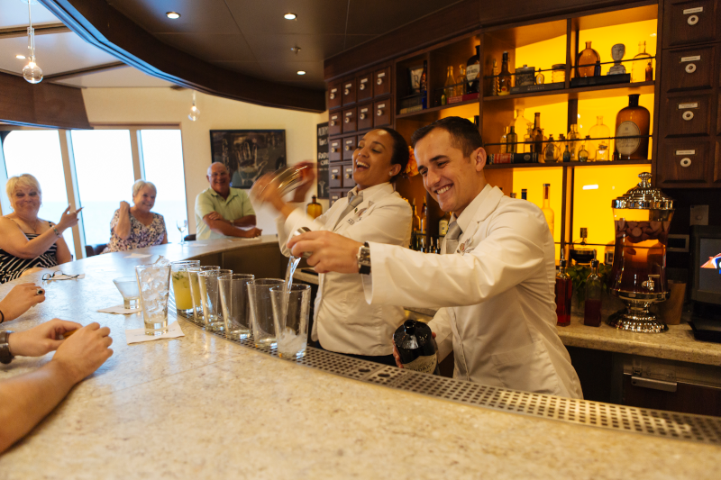 Bartenders preparing cocktails at Alchemy Bar on Carnival SEA Cruise adults only sailing