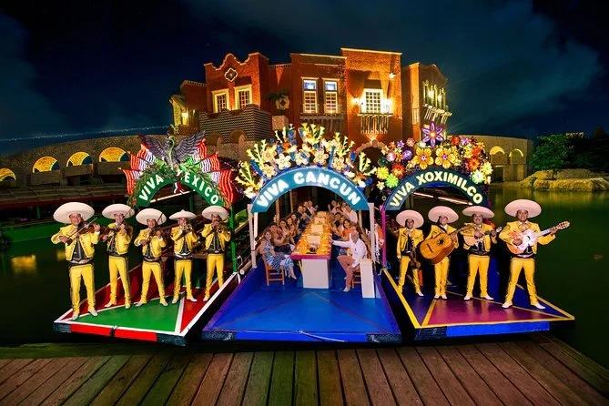 Live mariachi musicians performing on trajineras during the Xoximilco Xcaret floating dinner party.