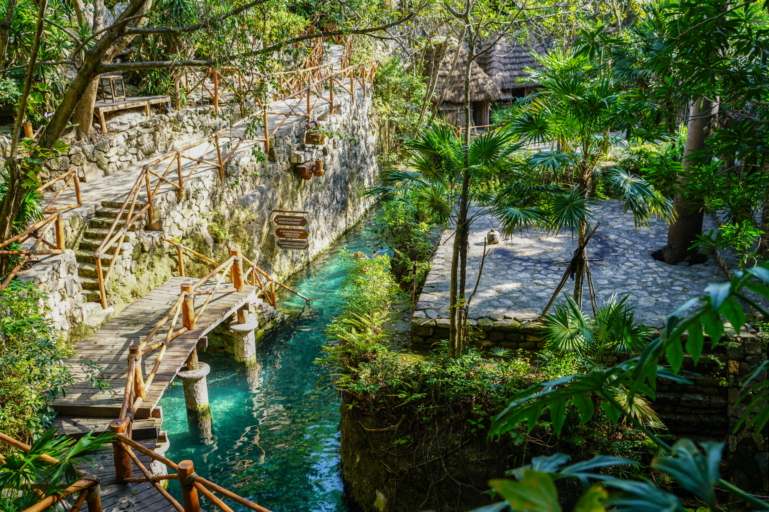 River pathway in Xcaret Park with exit stairs leading to the Mayan Village area