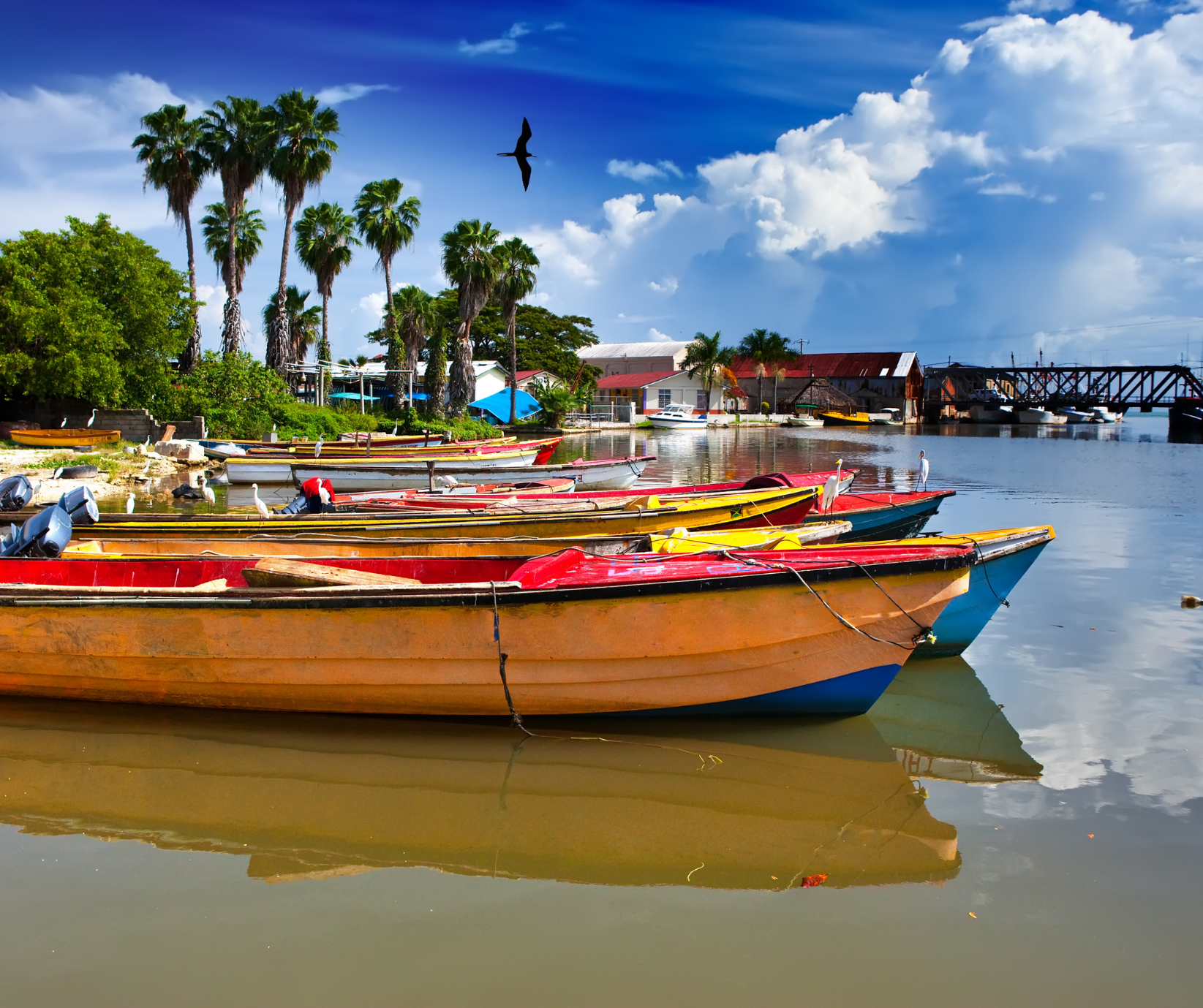 Colorful fishing boat resting on a quiet beach along Jamaica's peaceful South Coast.