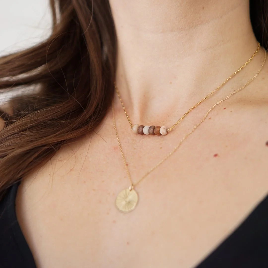 Model wearing a dainty matte red lace agate necklace with a gold filled paperclip chain, styled as a layering piece at the collarbone