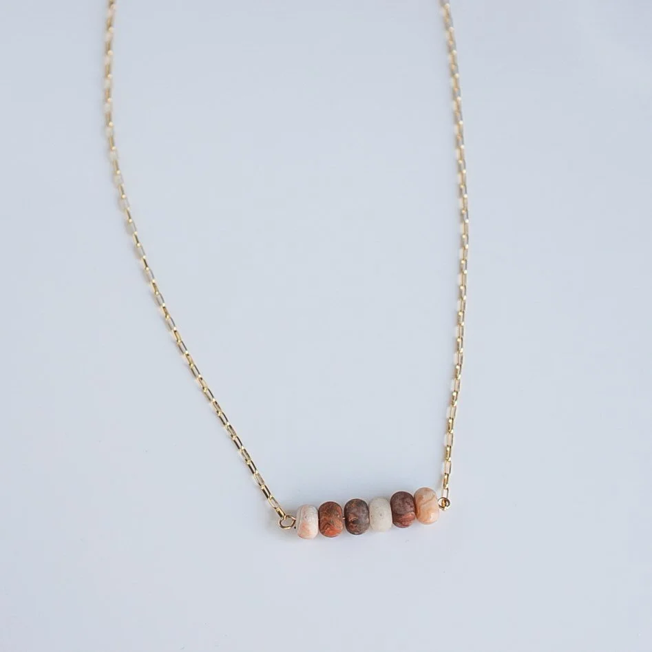 16" red lace agate bead bar necklace with six matte gemstone beads on a 14k gold filled elongated rolo chain, flat lay on a white background