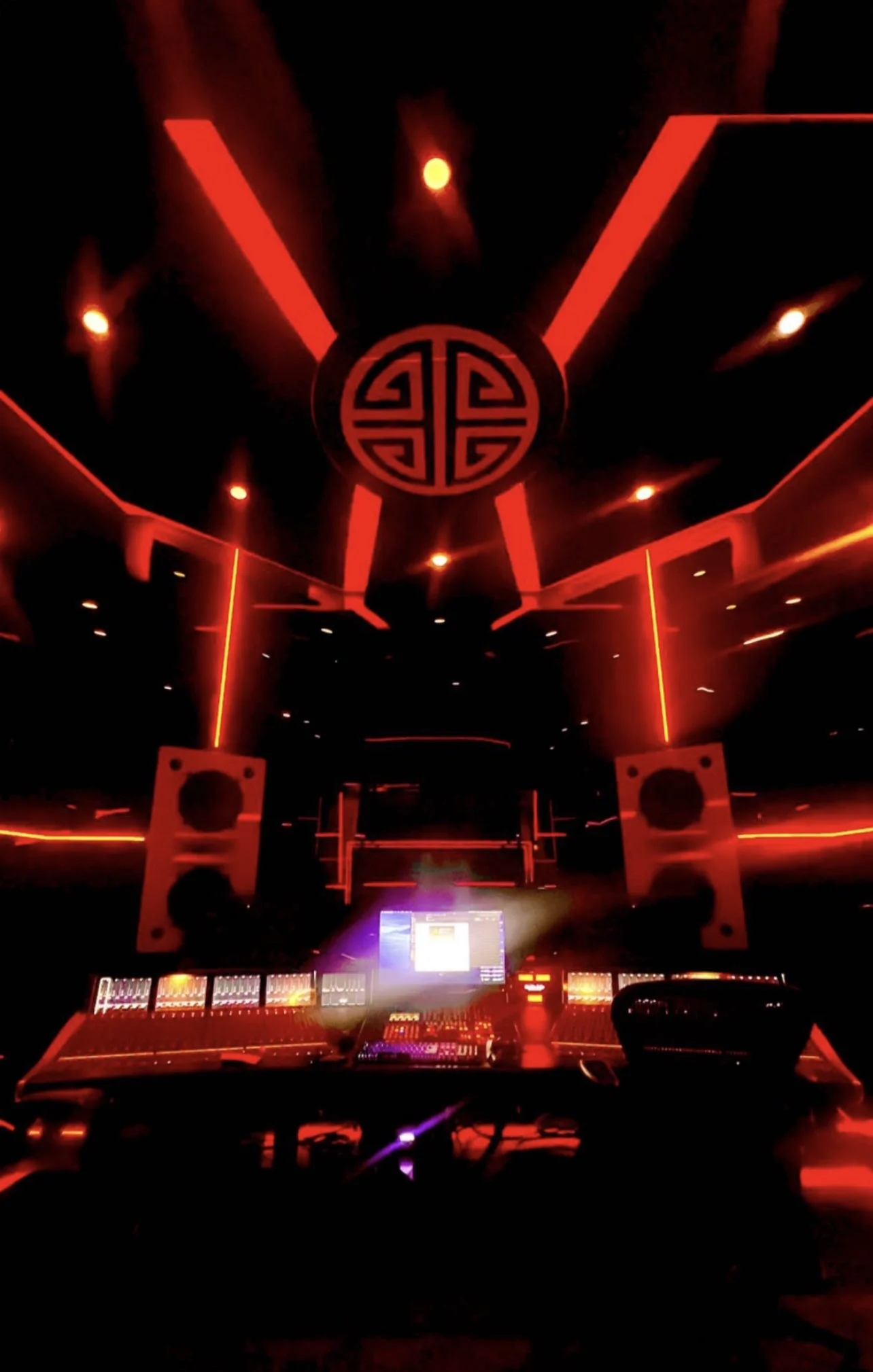 Modern music studio with red lighting and audio equipment