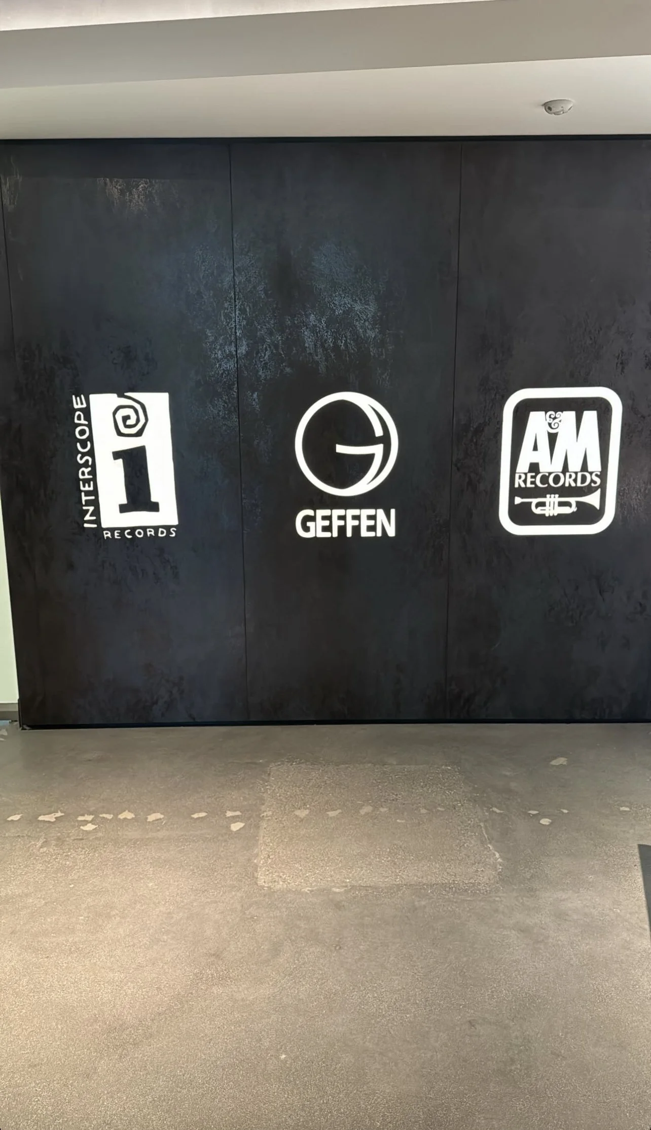 Lobby wall with logos of Interscope Records, Geffen Records, and A&M Records.