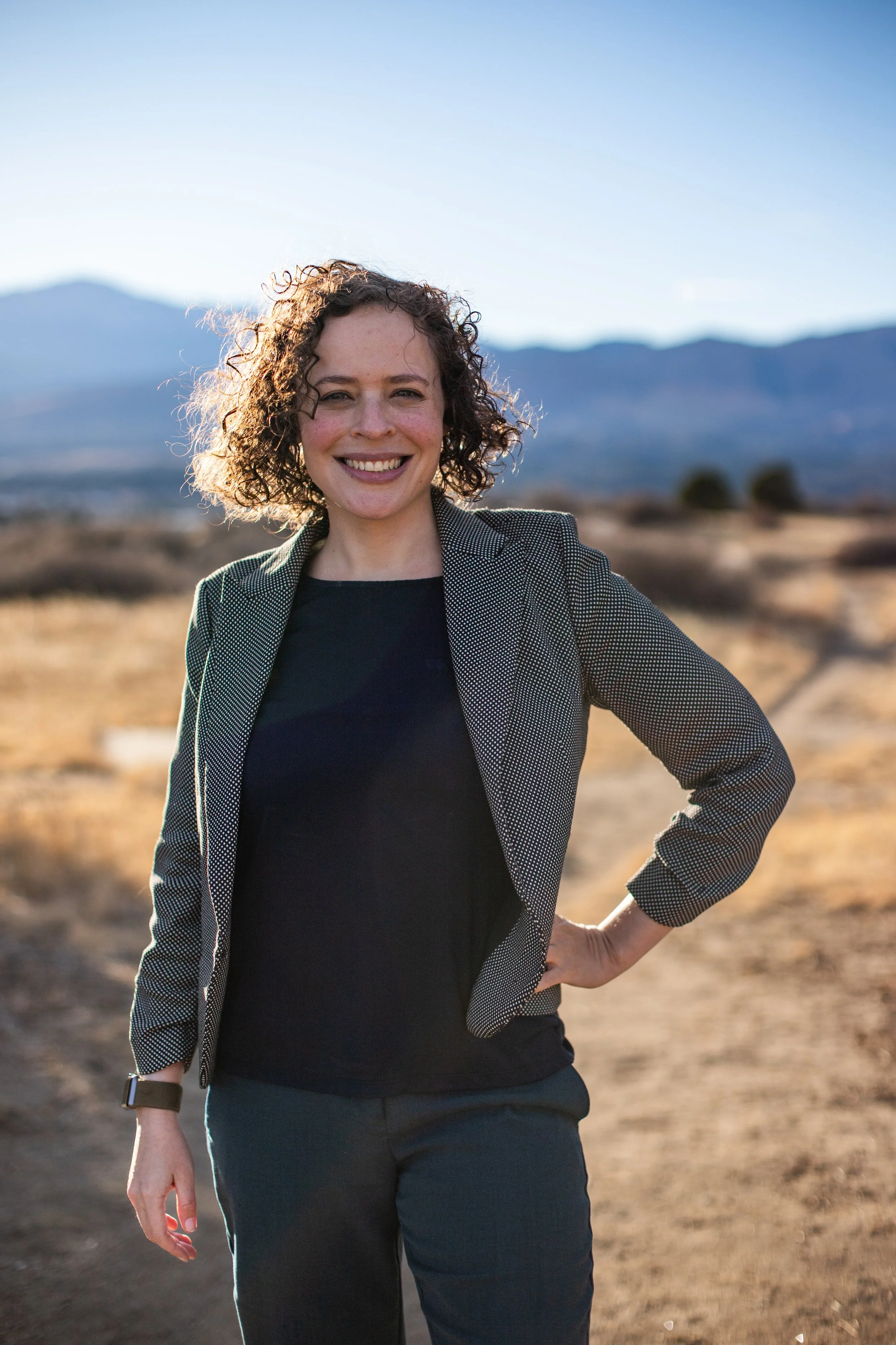 Picture of Zuri in business casual in front of the mountains