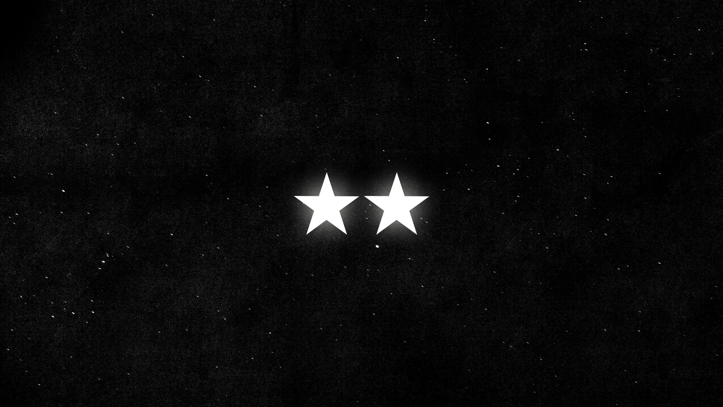 Due stelle bianche luminose su uno sfondo nero con piccoli punti che sembrano stelle