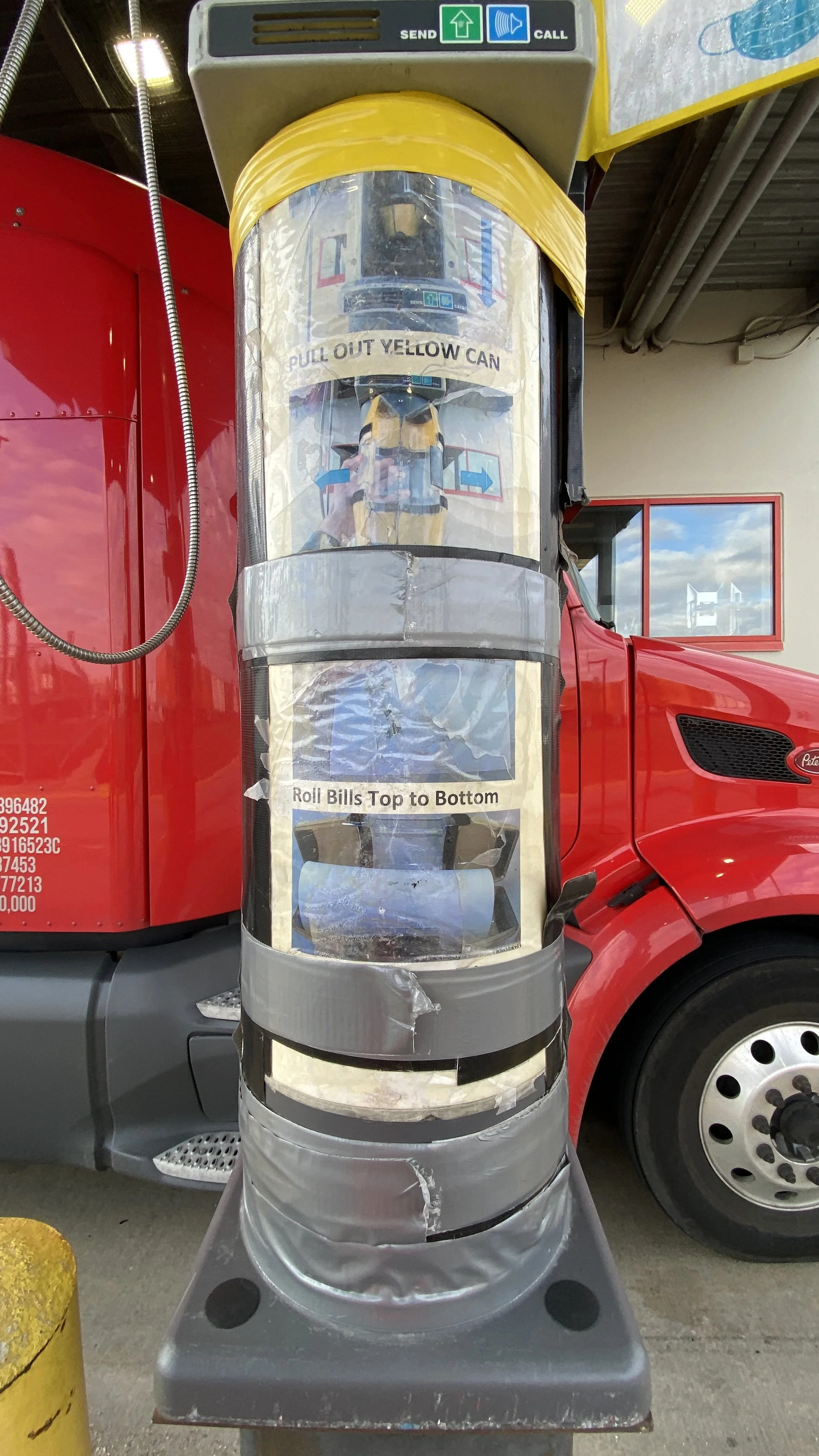 Red vehicle with an attachment recycling billboard that says "Pull out yellow can" and "Roll bills top to bottom."