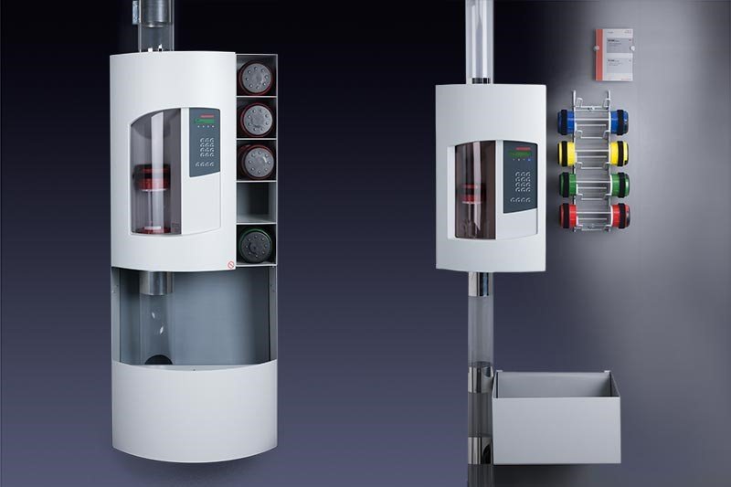Medical oxygen and compressed air equipment with gauges and control panel on a gray wall.