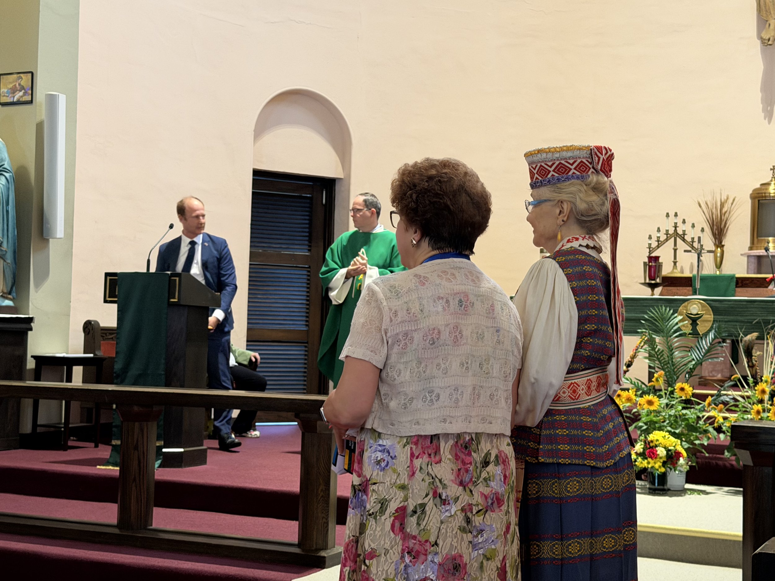 Marlene Warren, Council 7, and Barbara Schmidt, president of Council 141, accepting flags from the consul general