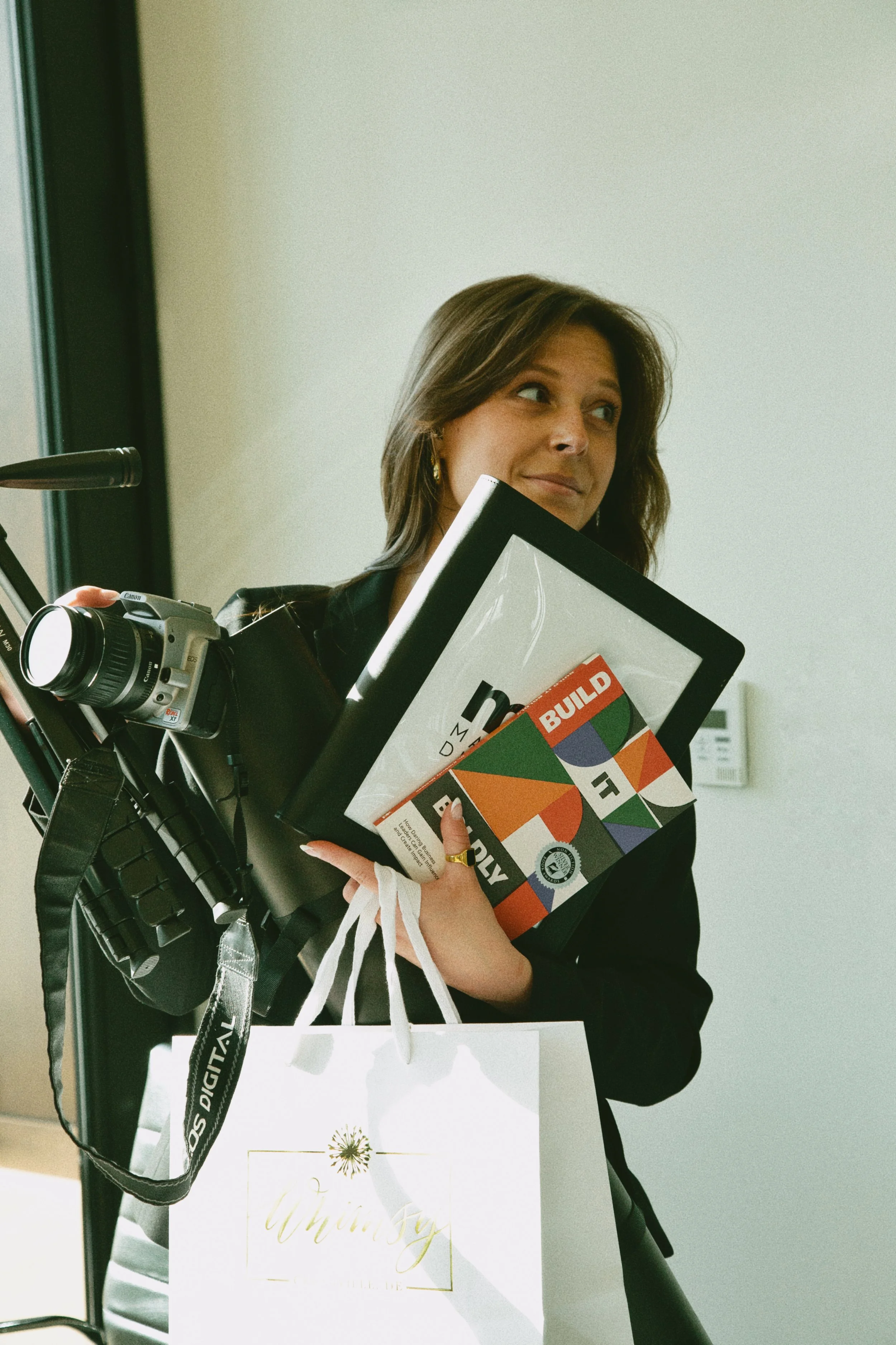 Kay Walker carrying content production gear and local business brand materials.