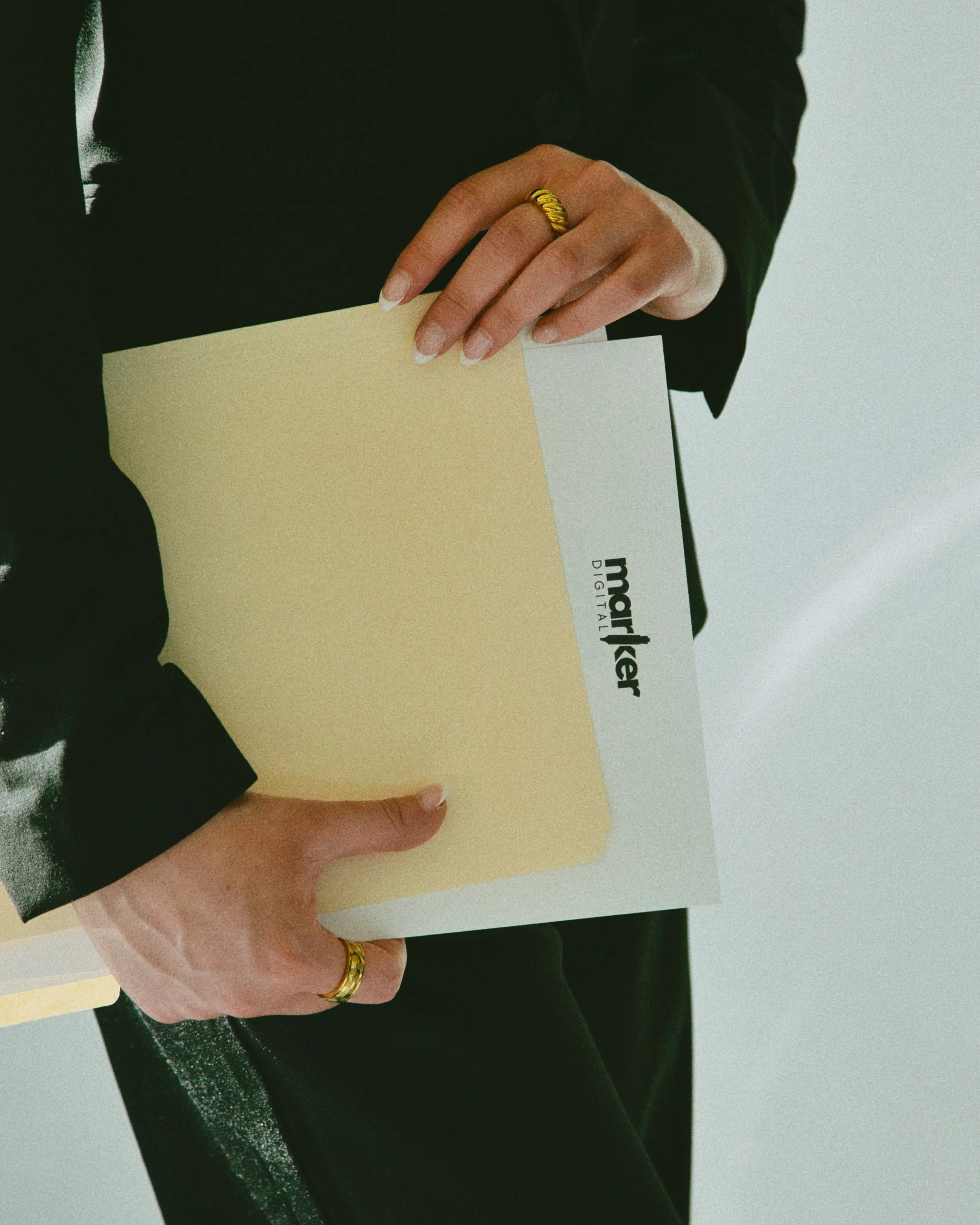 Marker Digital branded folder held by a team member.