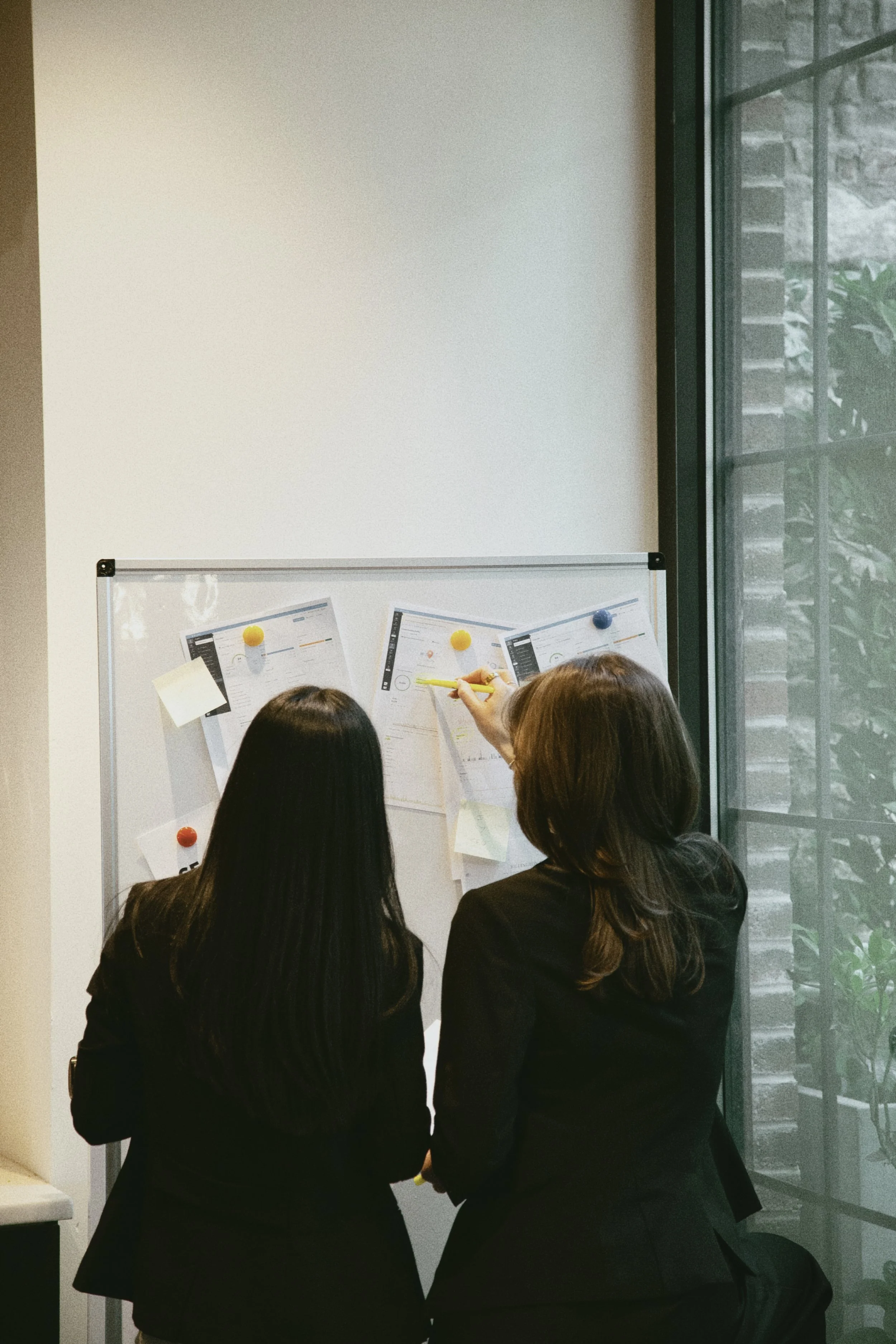 Marker Digital team reviewing local search performance data on a whiteboard.