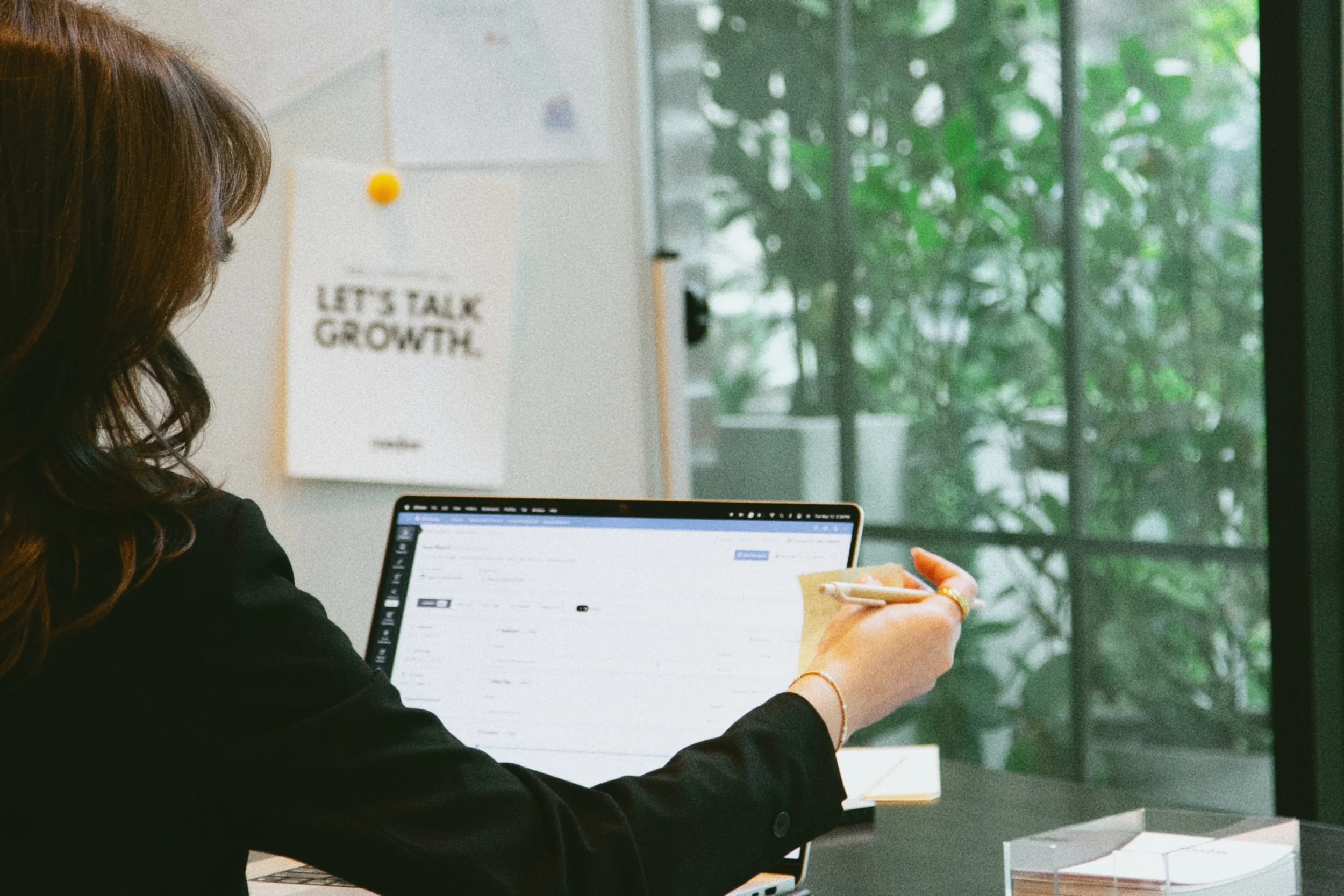 Kay Walker reviewing a digital marketing plan on a laptop.