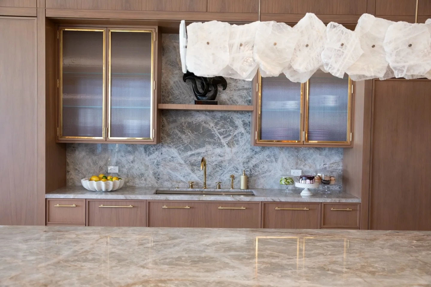 Designed by Christopher Boots, the Petra chandelier is more than lighting, it&rsquo;s a study in nature, materiality, and time. 

When designing this kitchen, we were drawn to that same language. The Cristallo quartzite, with its soft veining and nat