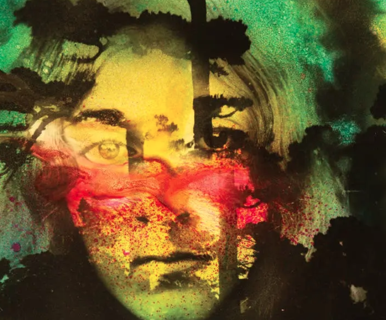 An artistic portrait of a person's face superimposed with vibrant watercolor splashes in green, yellow, red, and black.