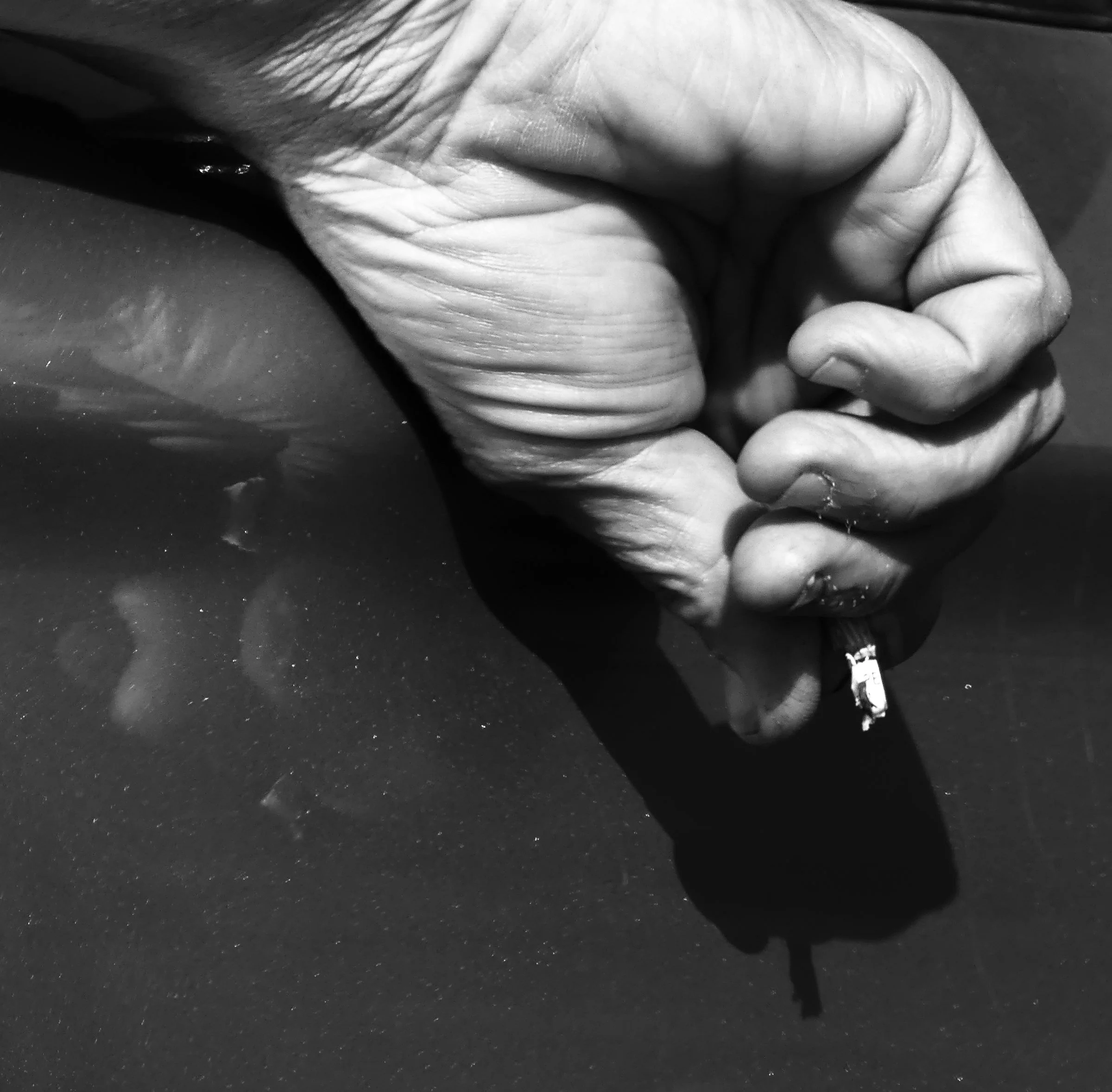 Man holding cigarette out of car window, Towradgi Australia