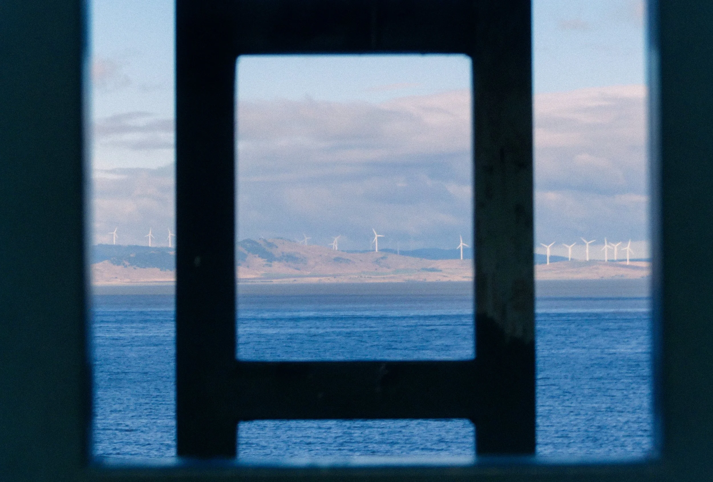 Funnelling vision of the windmills over a flooded lake at a Canberra rest stop